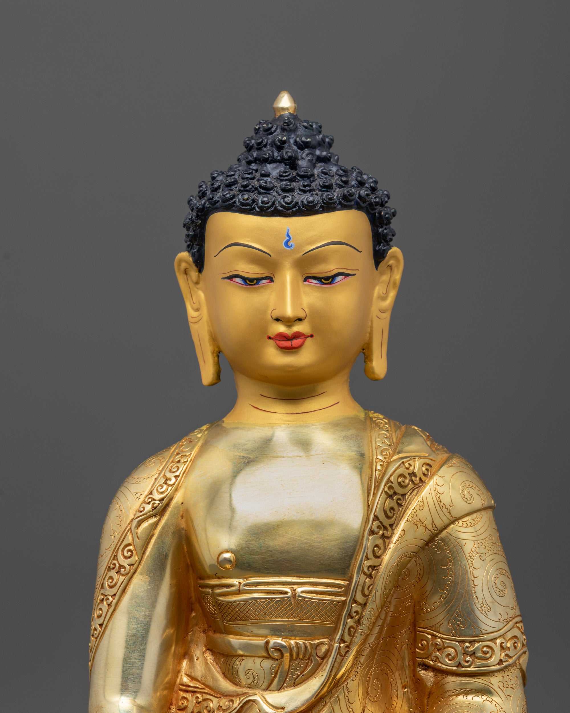 Close-up of Amitabha Buddha face with 24k fire gold gilded finish