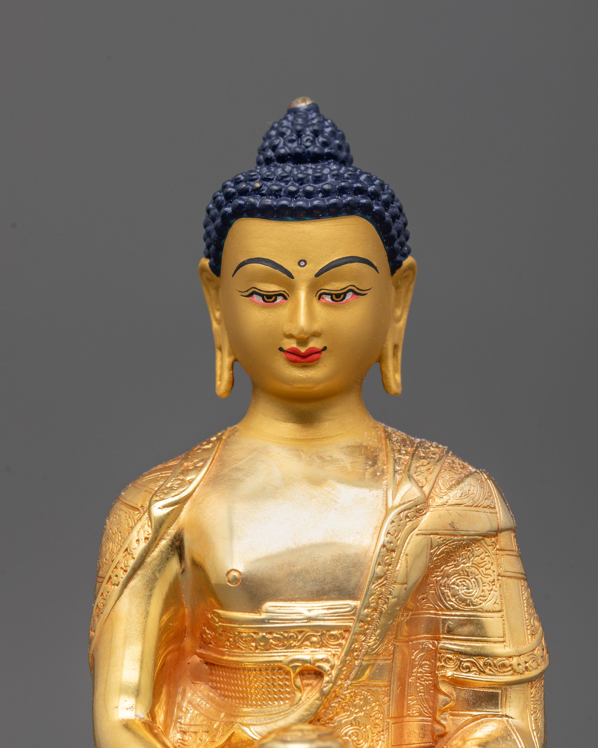 Close-up of Amitabha Buddha's tranquil facial expression with intricate crown