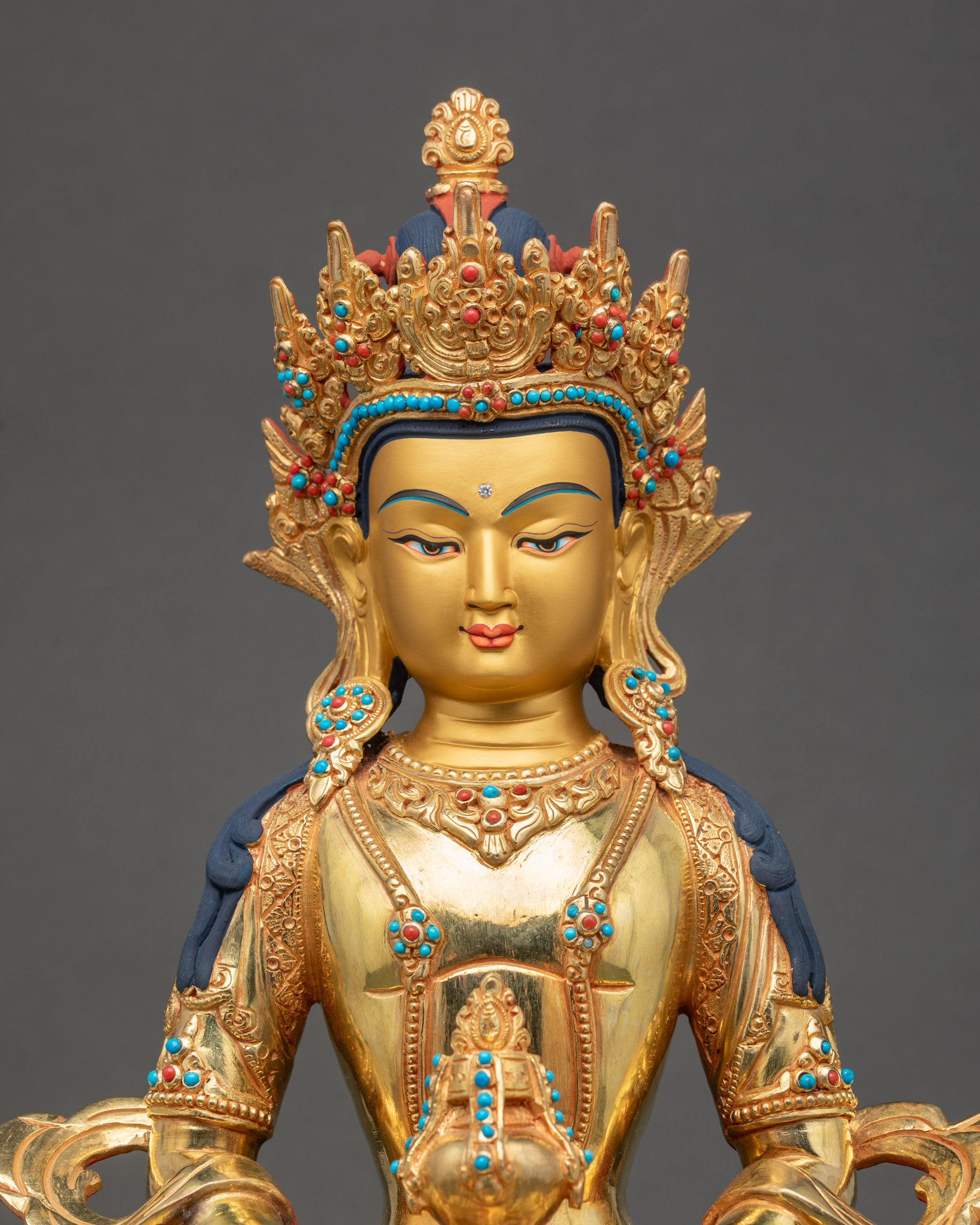 Close-up of Amitayus Buddha face, 24K gold-painted, radiant and serene expression