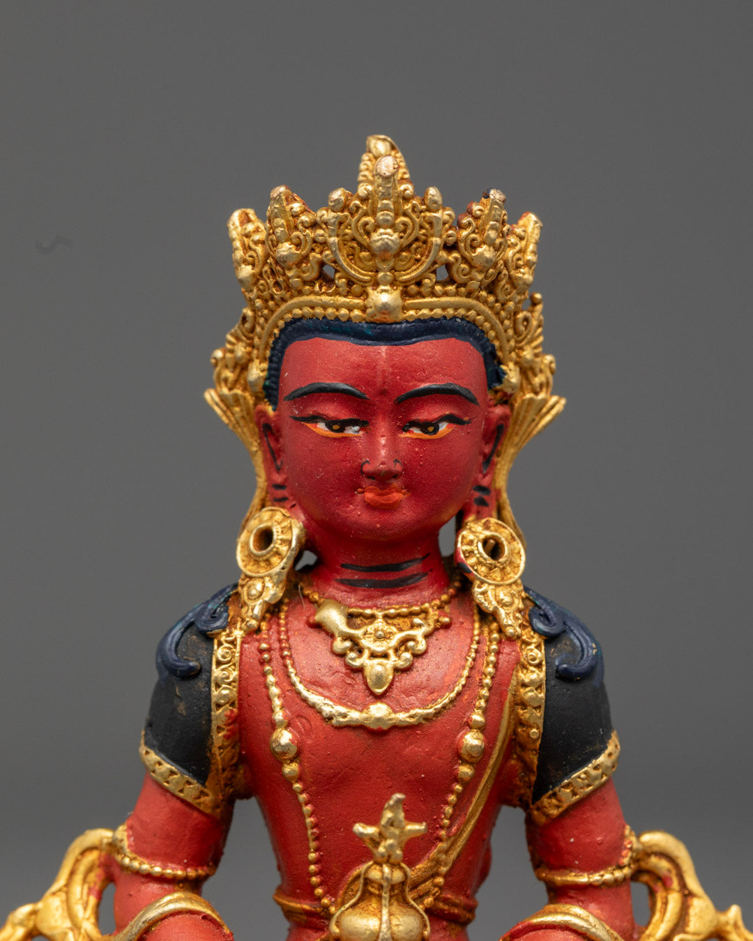 Amitayus Buddha face, showcasing serene expression, detailed crown, and hand-painted features with vibrant colors.