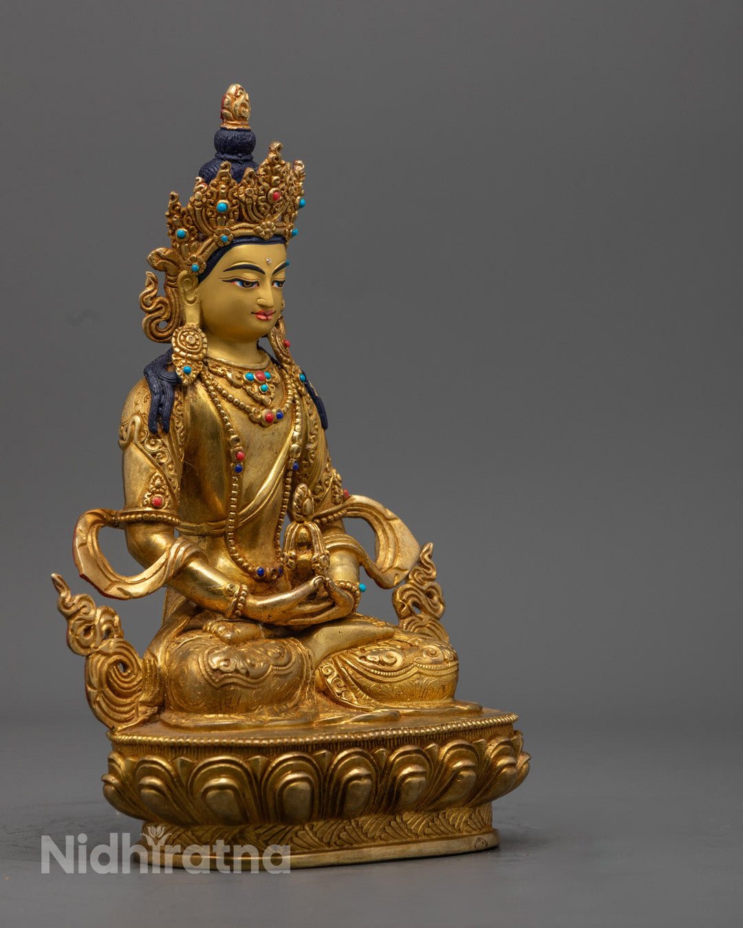 Close-up of Amitayus Buddha’s serene face with jeweled crown, symbolizing longevity and spiritual blessing