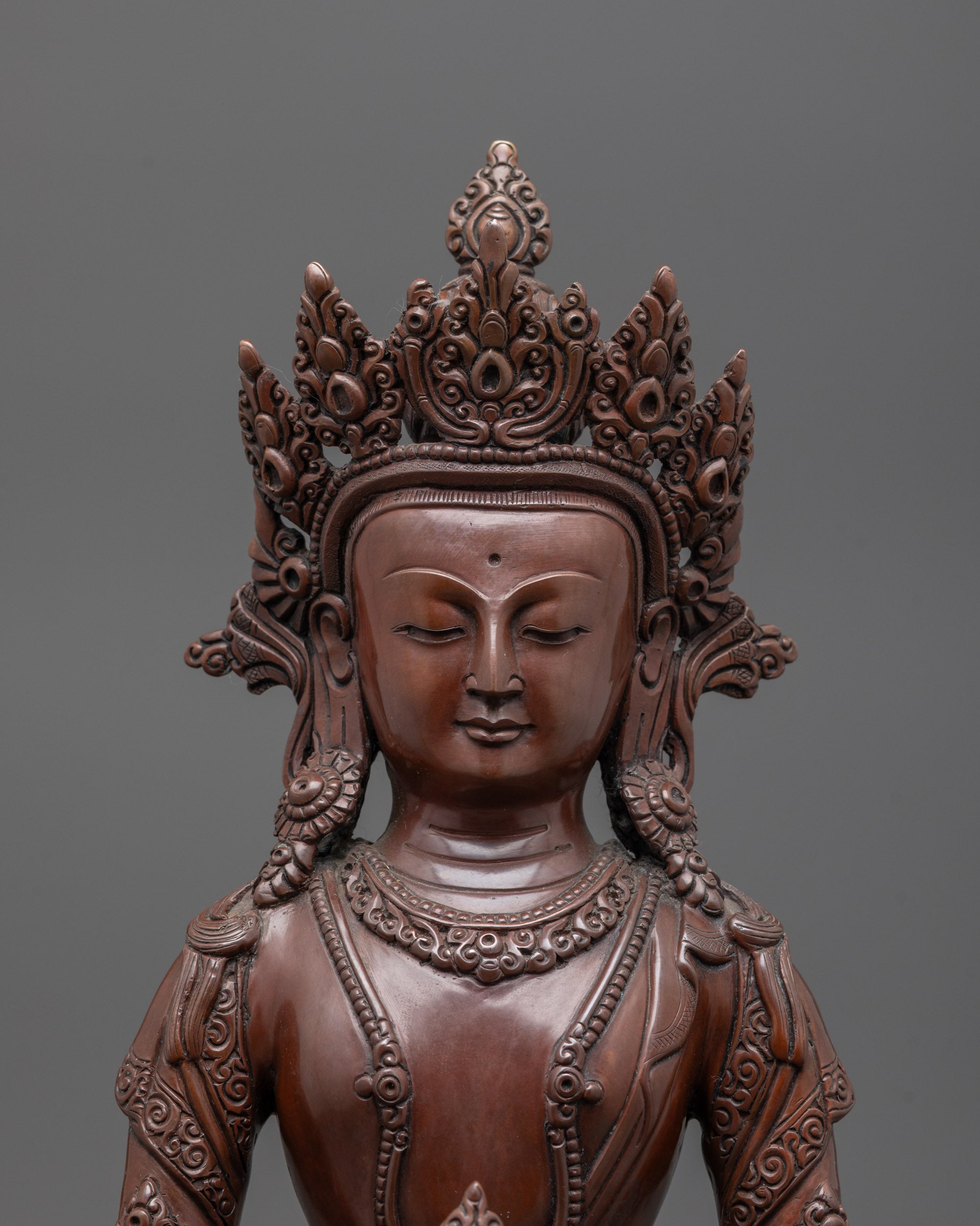 Close-up of Amitayus Statue's five-jeweled crown and serene facial expression