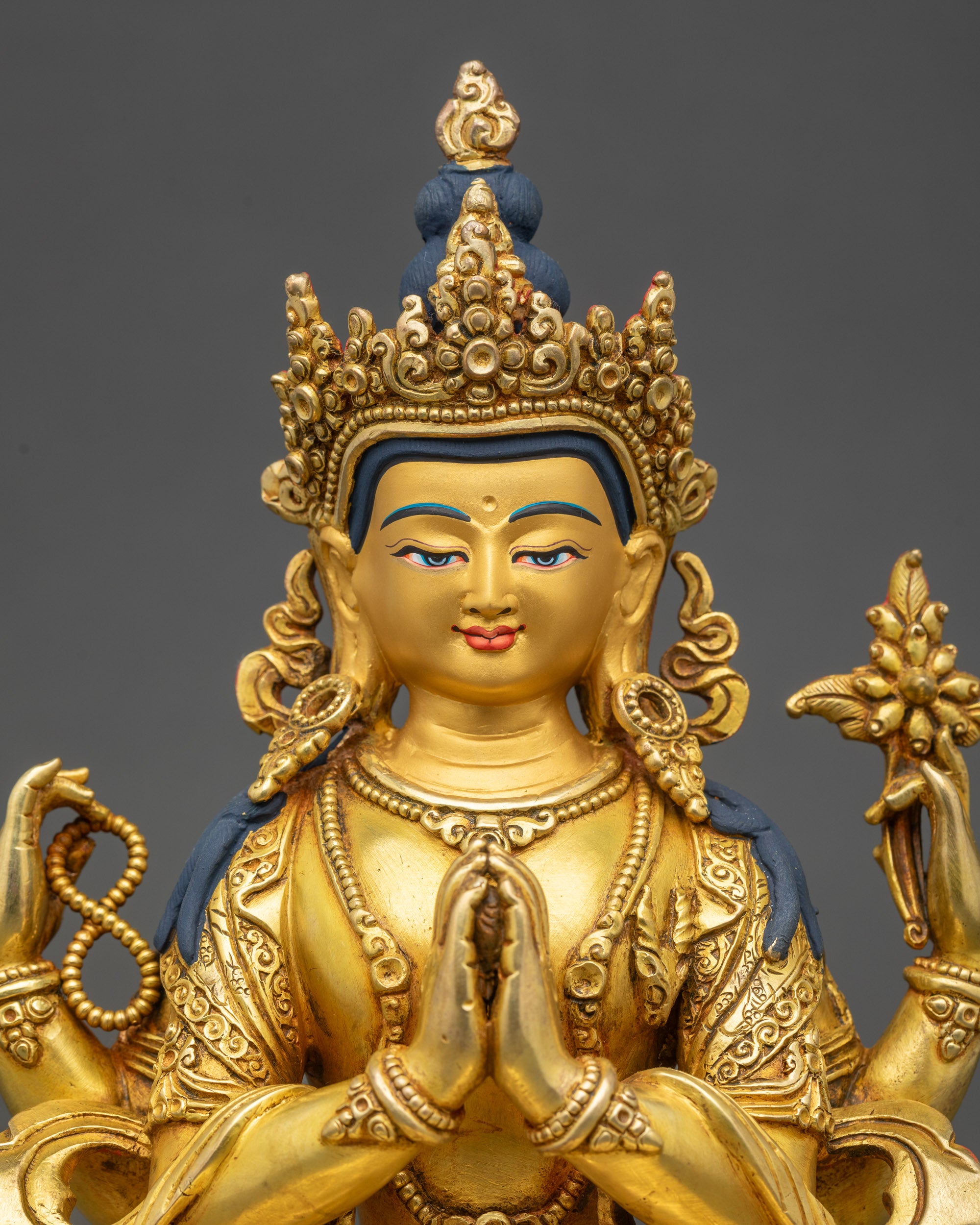 Close-up of Avalokiteshvara face showing serene expression and gold detailing