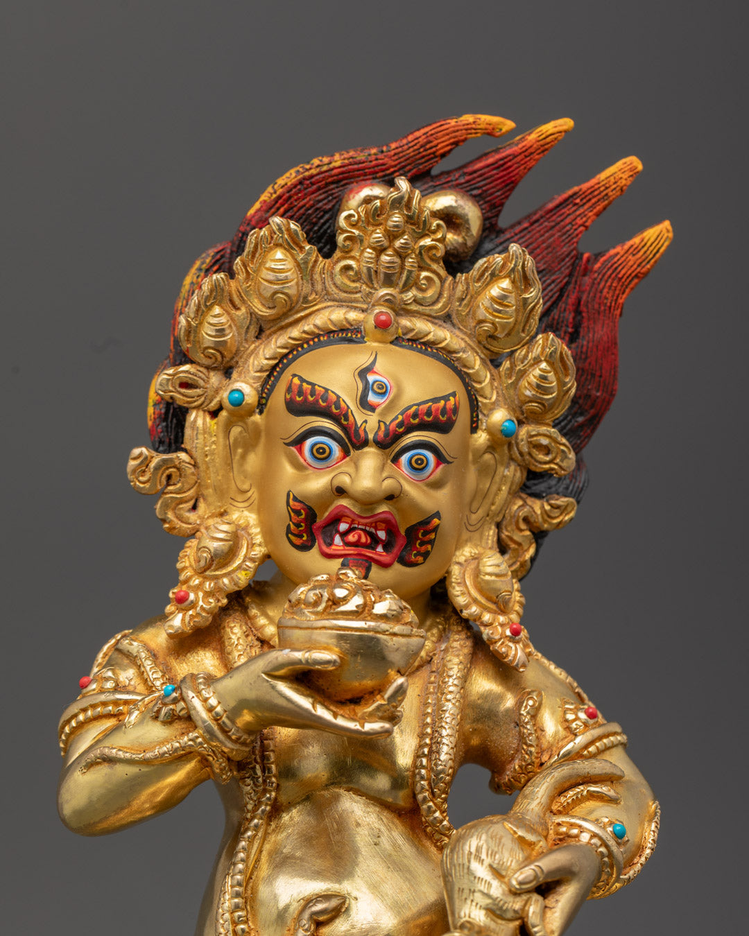 Black Dzambhala’s serene face with intricate acrylic detail and third eye, symbolizing wealth and protection.