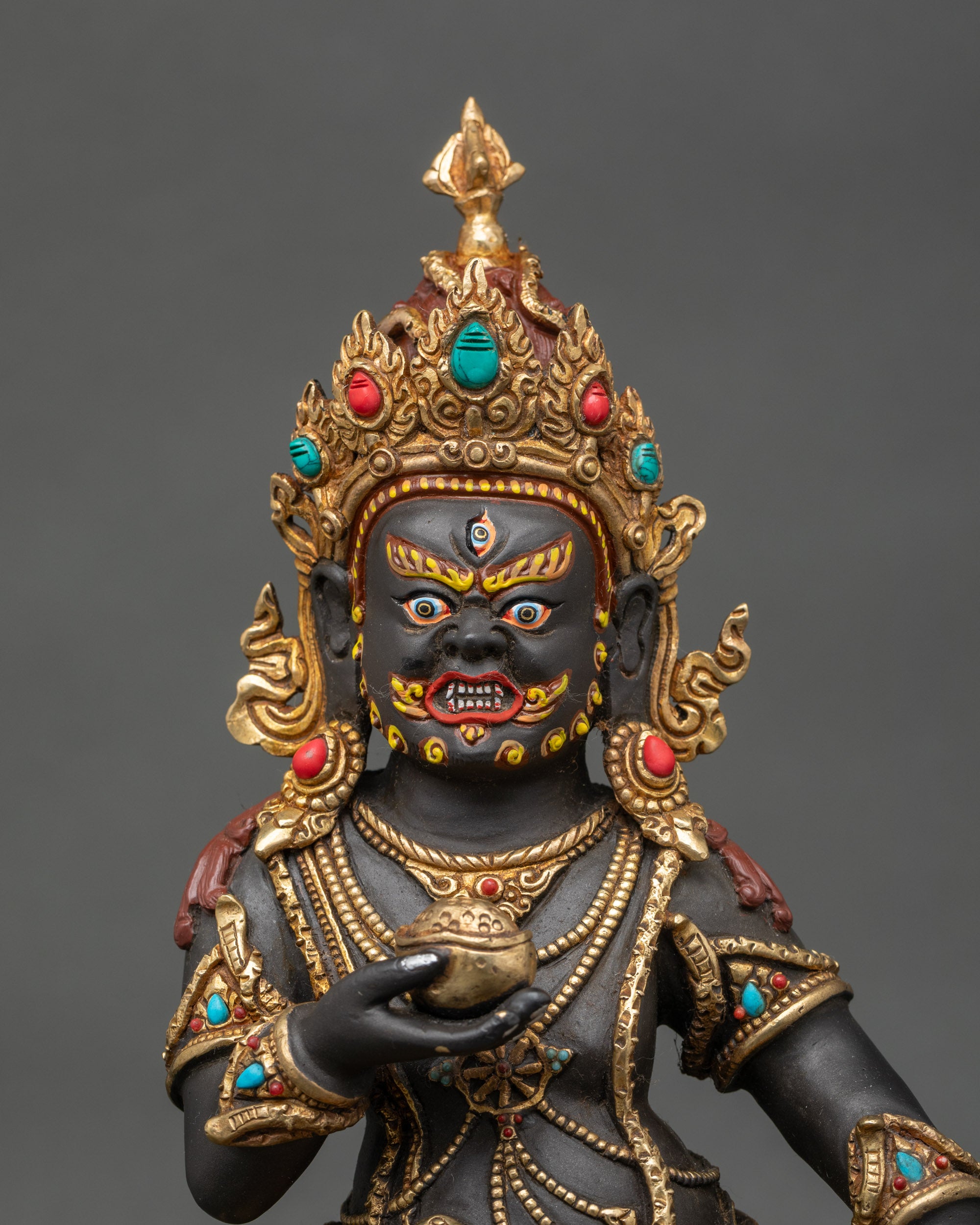 Close-up of Black Dzambhala statue showing intricate copper and acrylic details