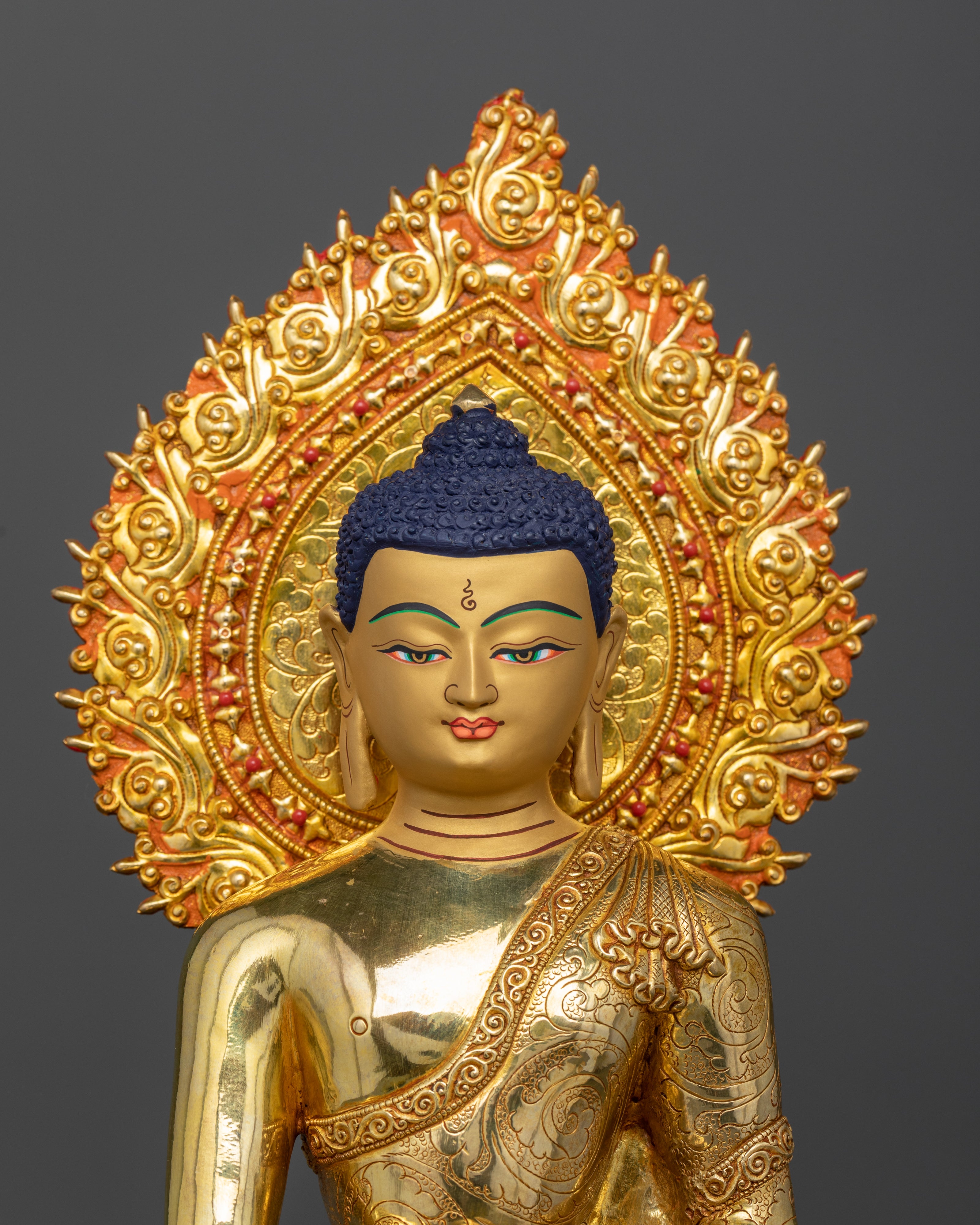Close-up of Buddha’s 24K gold-painted face with serene expression, Himalayan sculpture
