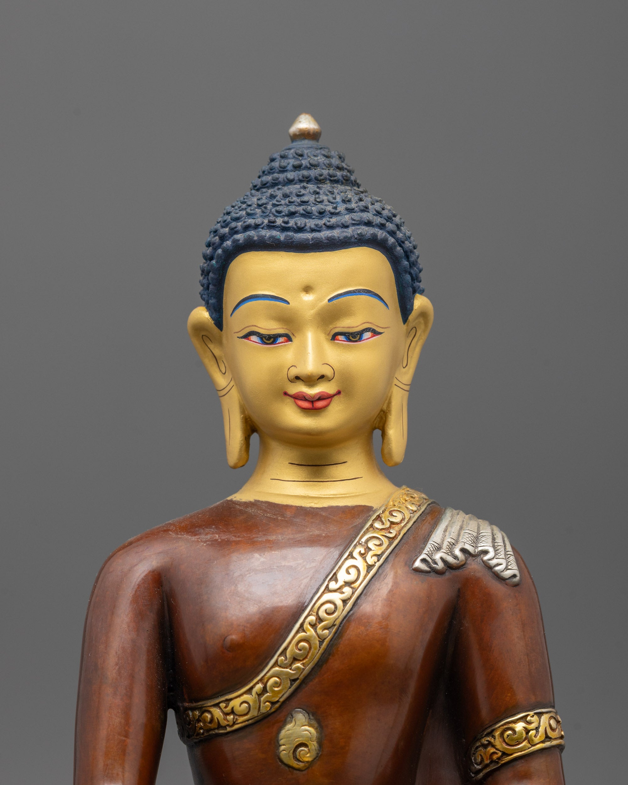 Close-up of Buddha’s oxidized copper body, detailed robes, patra bowl, and gold & silver plating