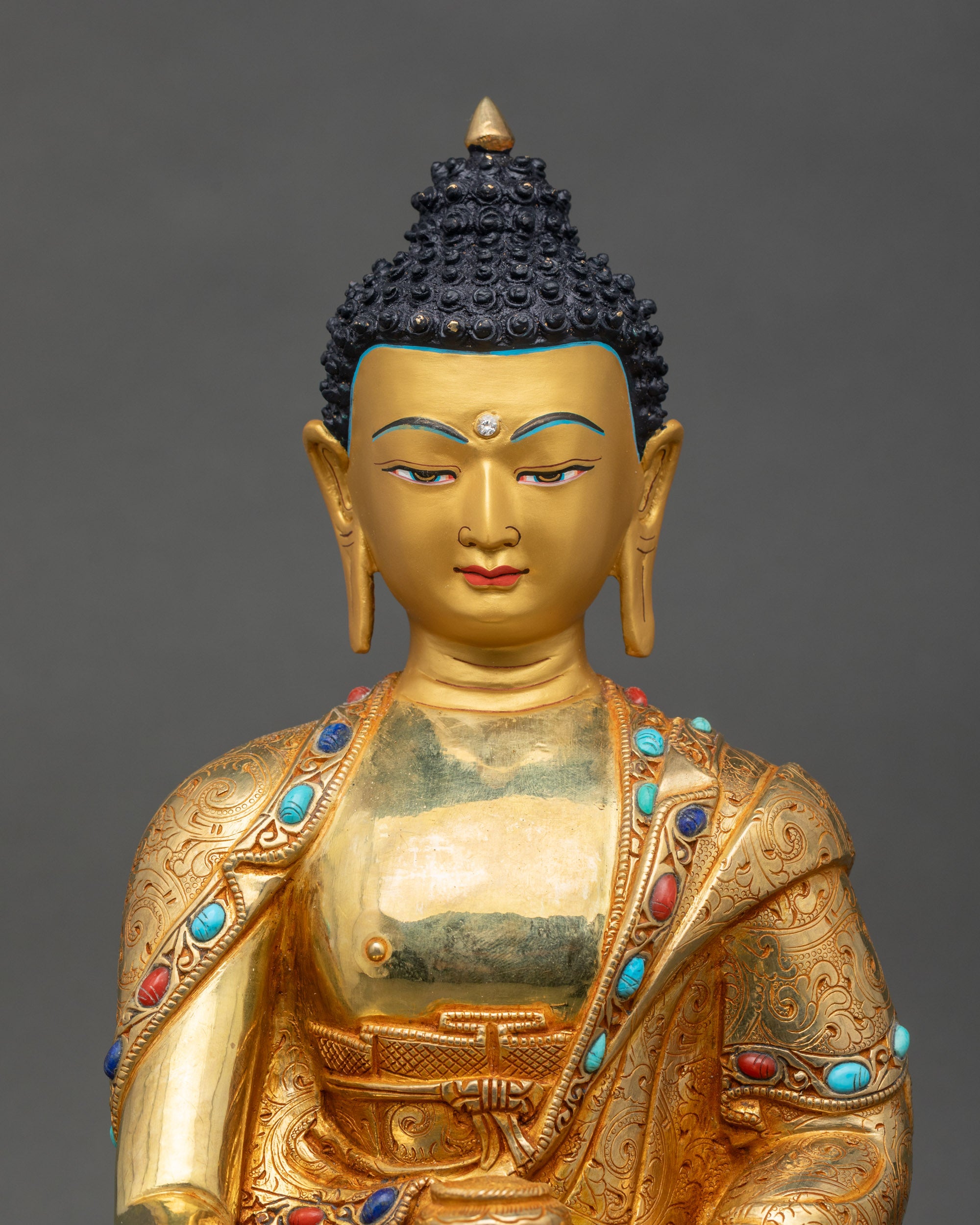 Close-up of Buddha sculpture showing serene face and intricate robes