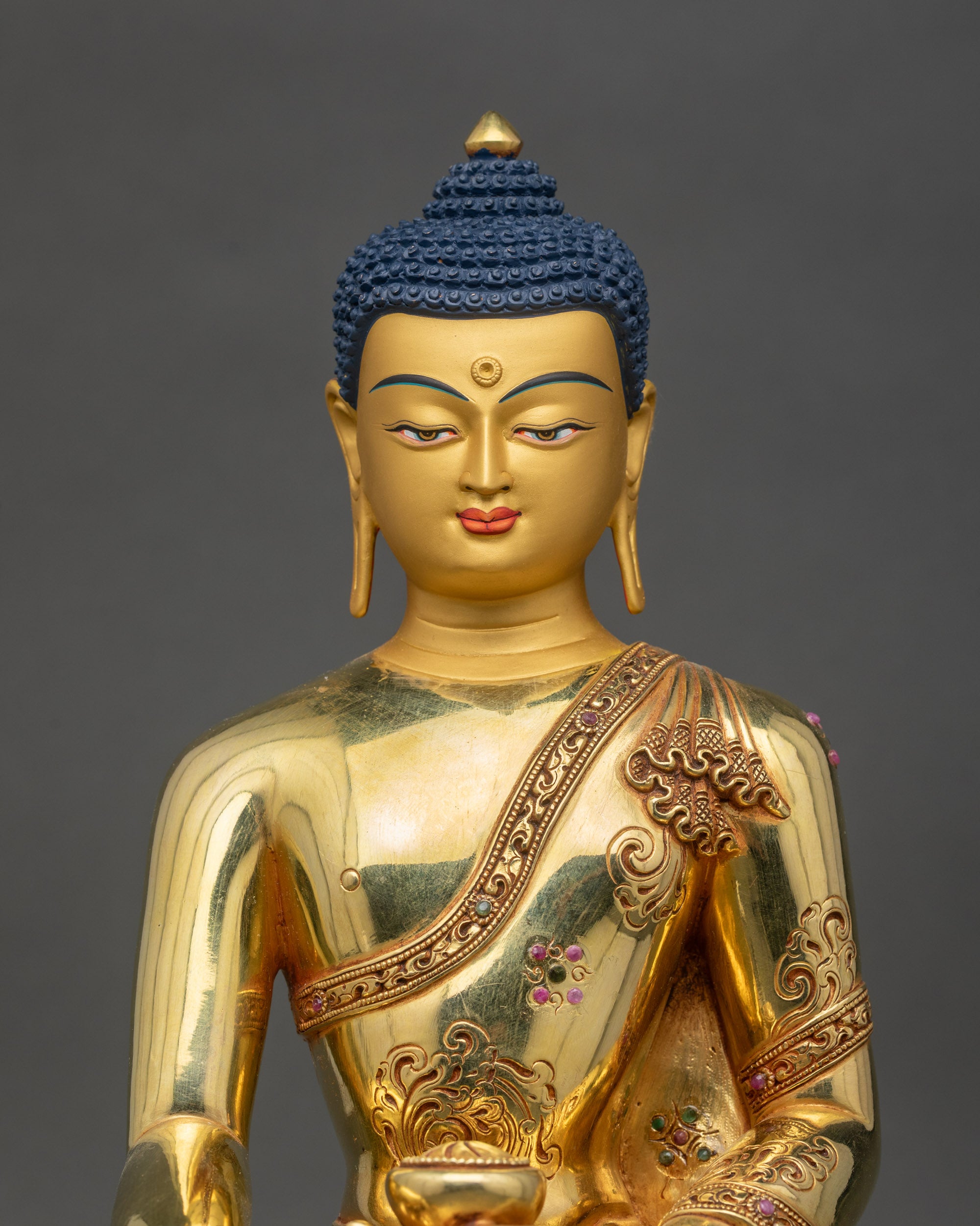 Close-up of Buddha statue, detailed copper craftsmanship with gold accents