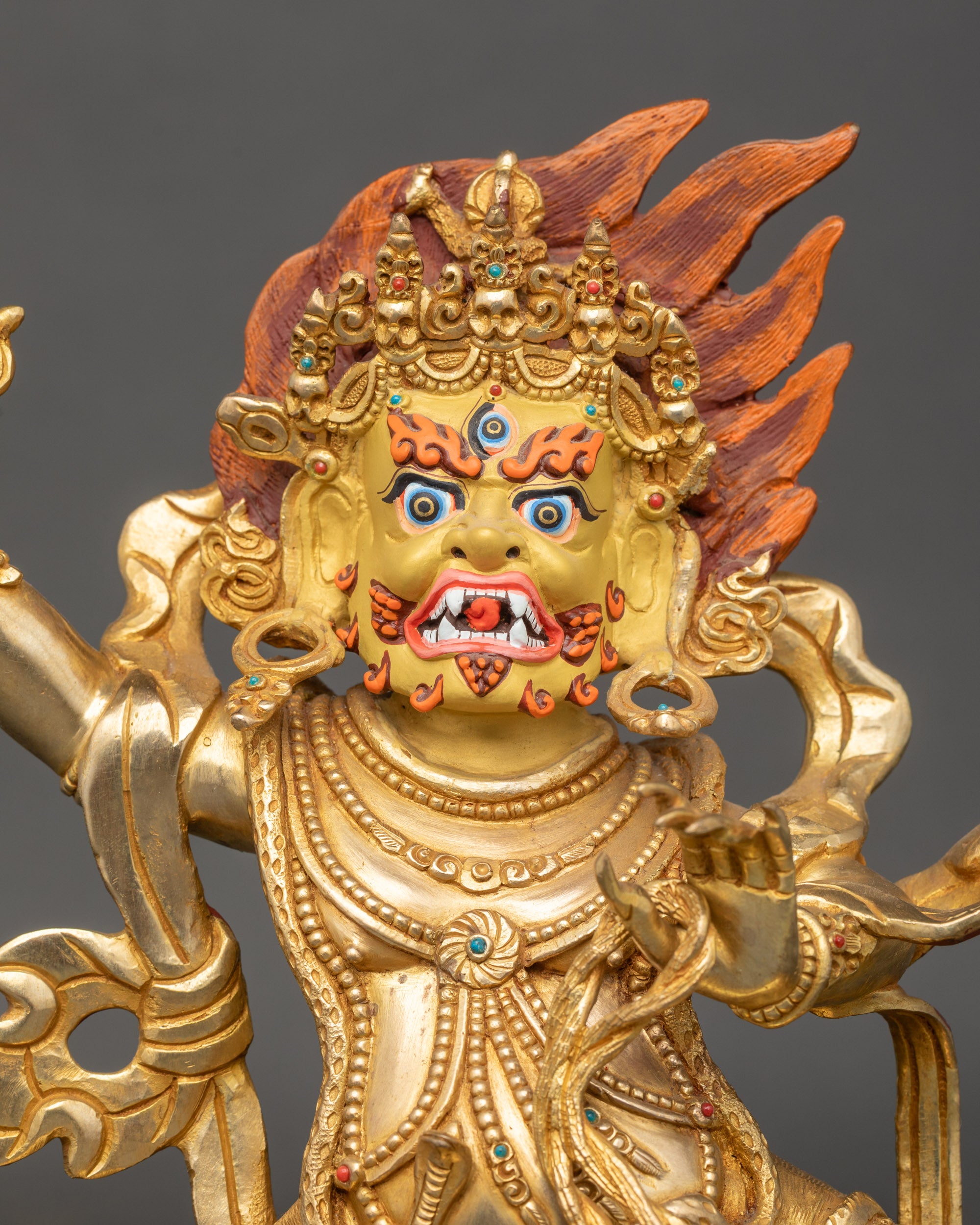 Close-up of Chana Dorje Vajrapani statue showing intricate gold fire-gilding and details
