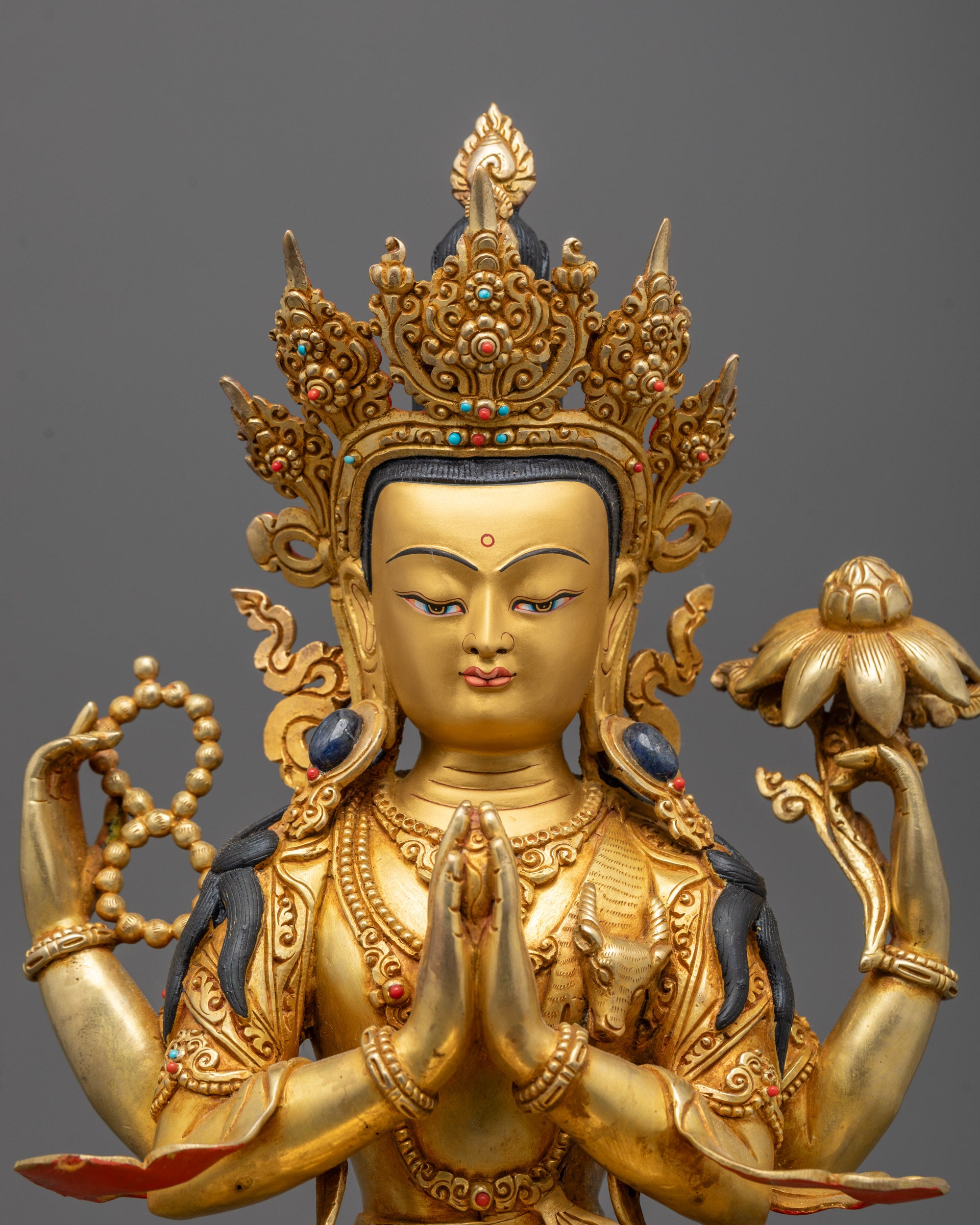 Close-up of Chenrezig Statue face adorned with a five-jewelled crown
