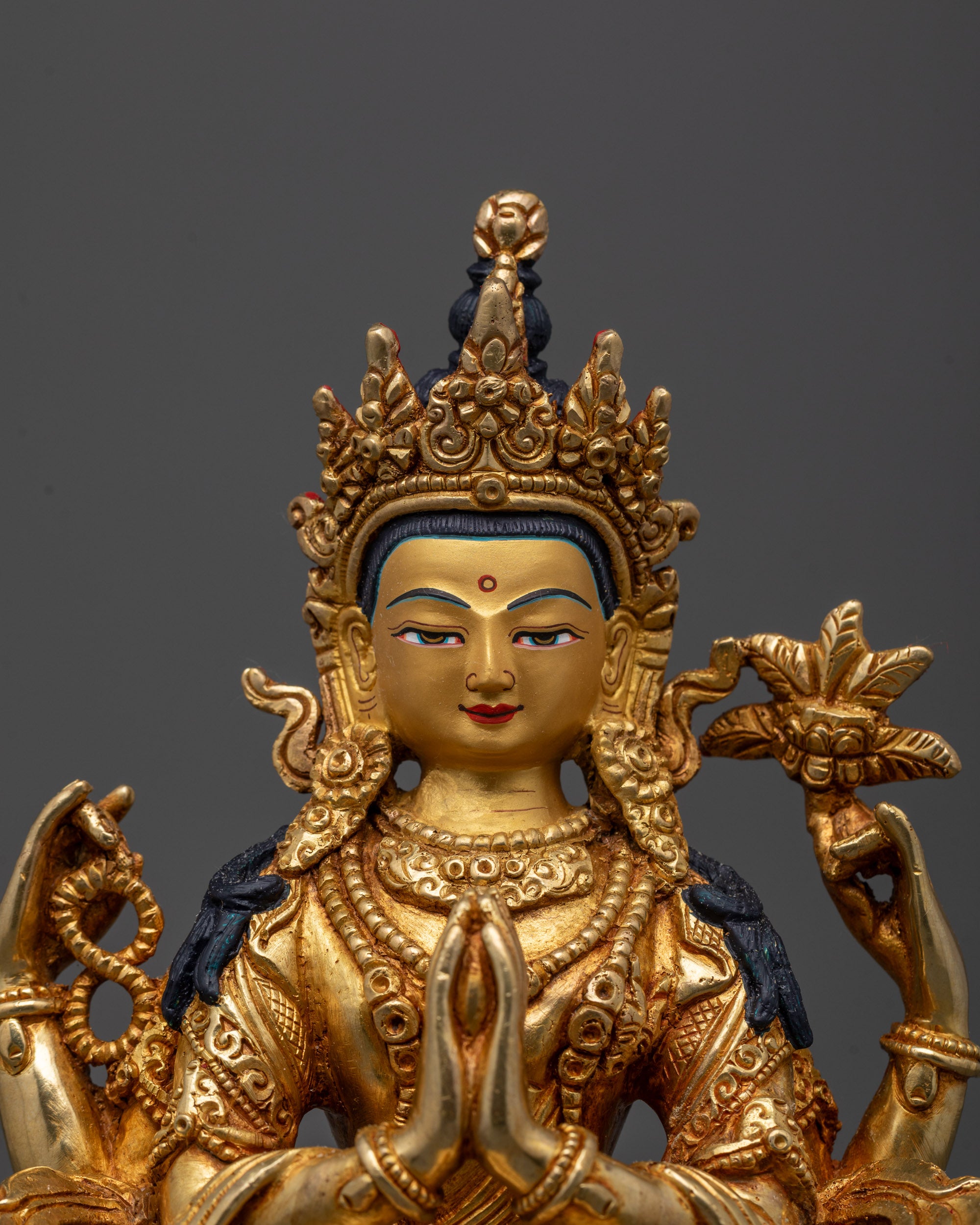 Close-up of Chenrezig’s compassionate face and intricate crown with gold gilding