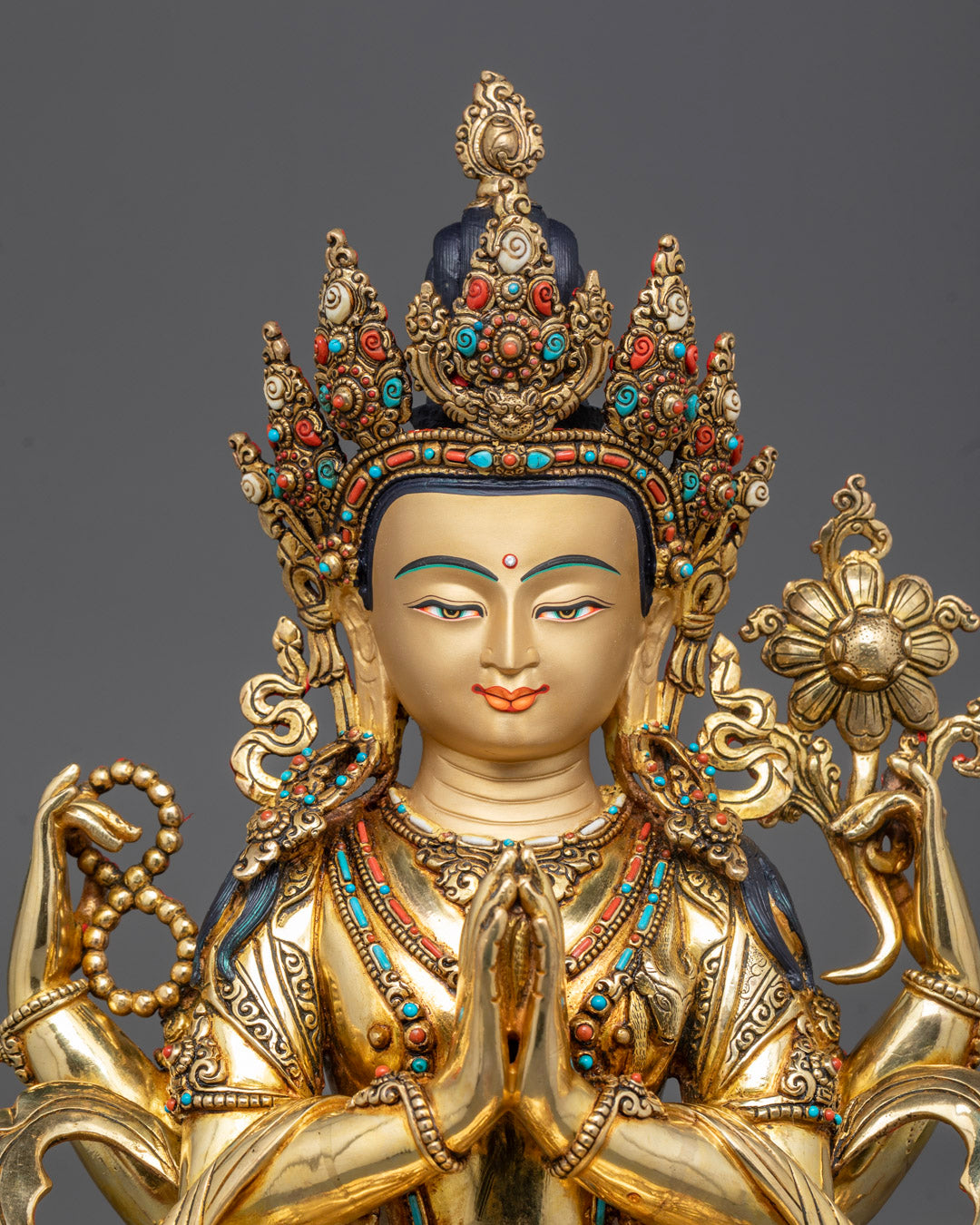 Close-up of Chenrezig’s gold-gilded face, 5-jeweled crown, and detailed jewelry