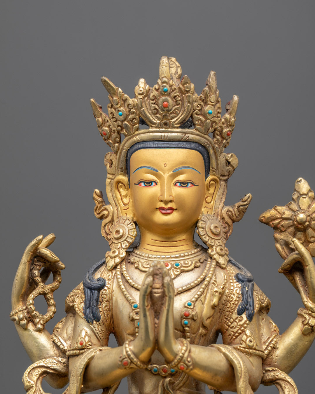 Close-up of Chenrezig’s gold face and detailed craftsmanship.