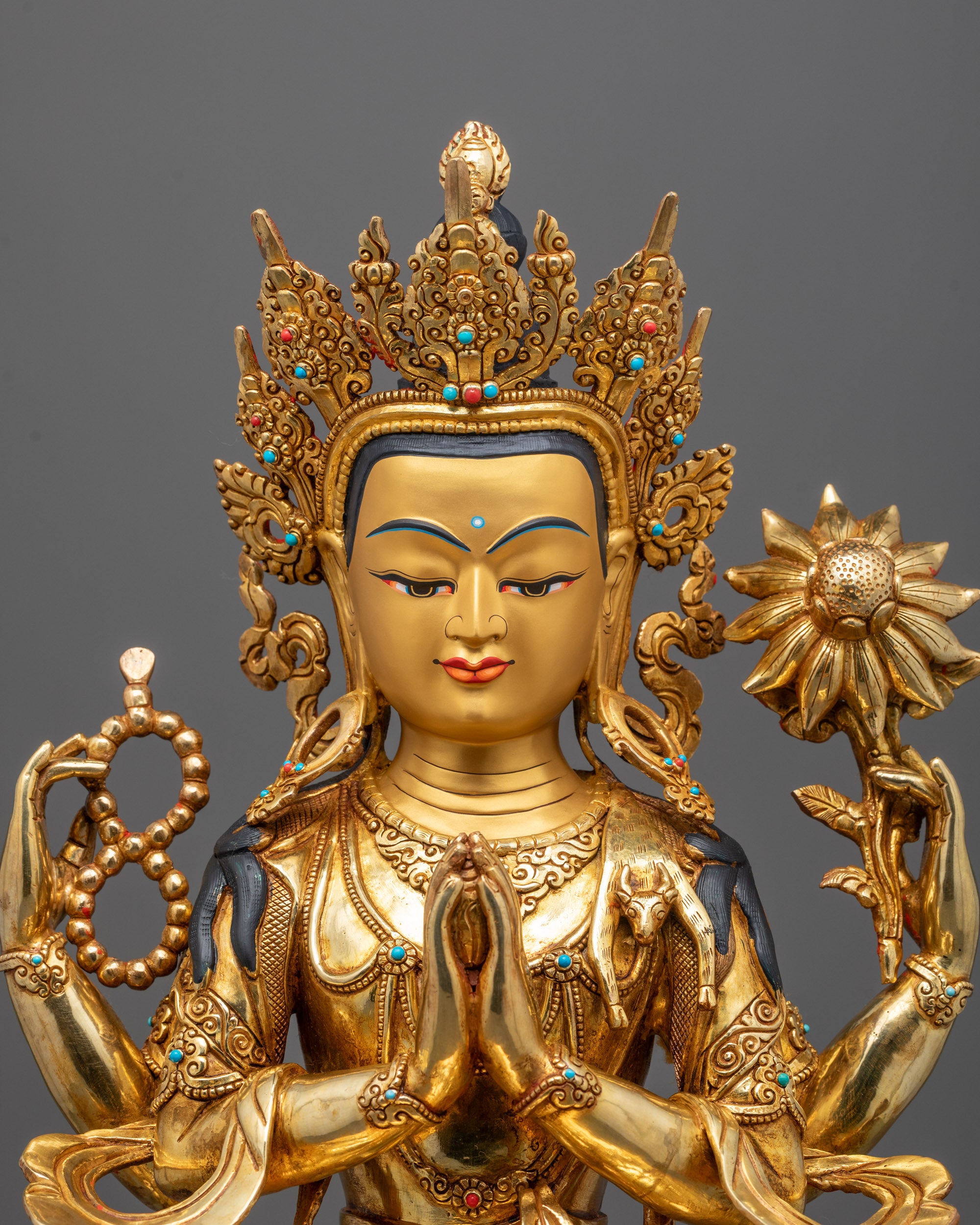 Close-up of Chenrezig’s peaceful face and gold-gilded crown
