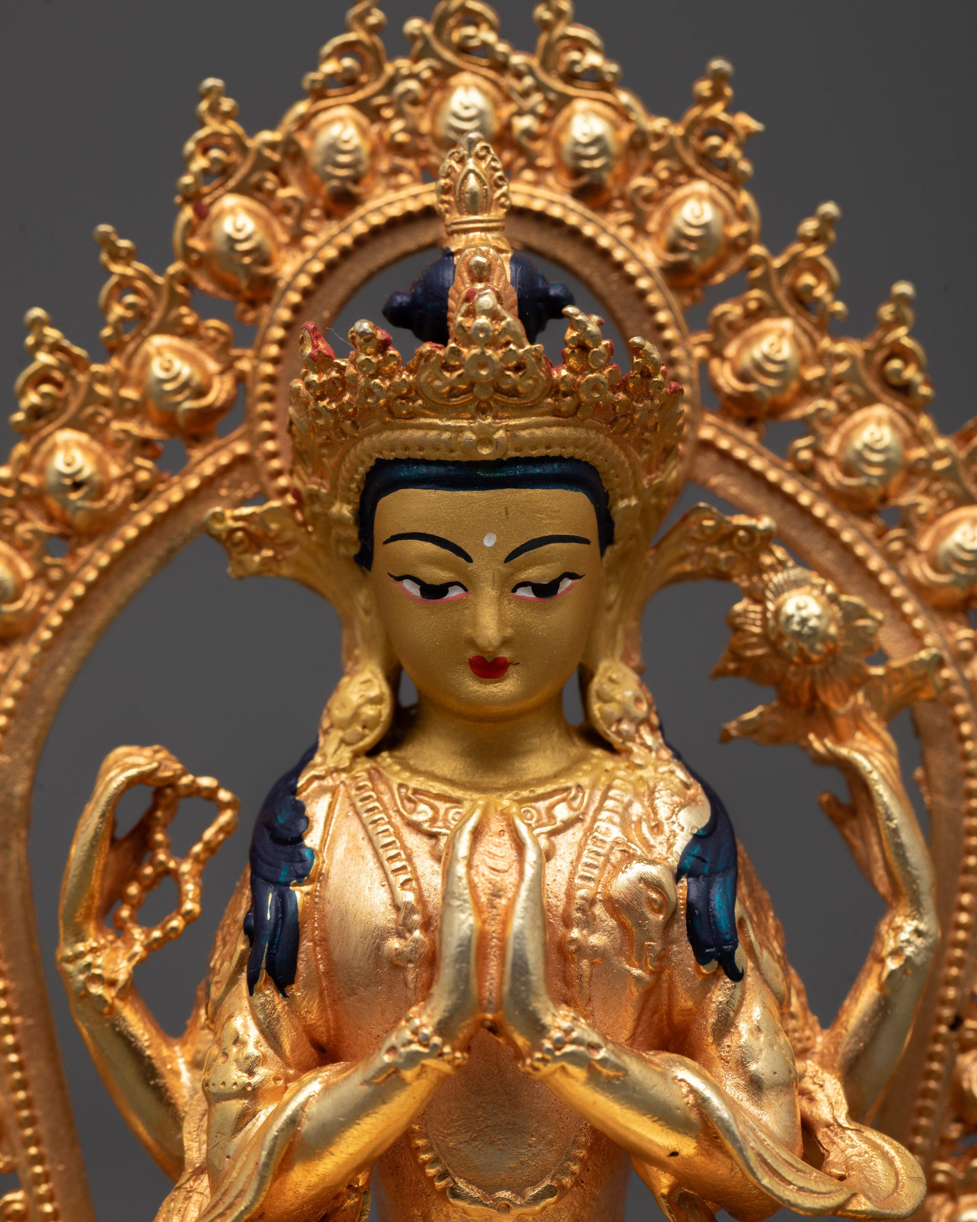 Close-up of Chenrezig's serene face and detailed crown, symbolizing divine compassion