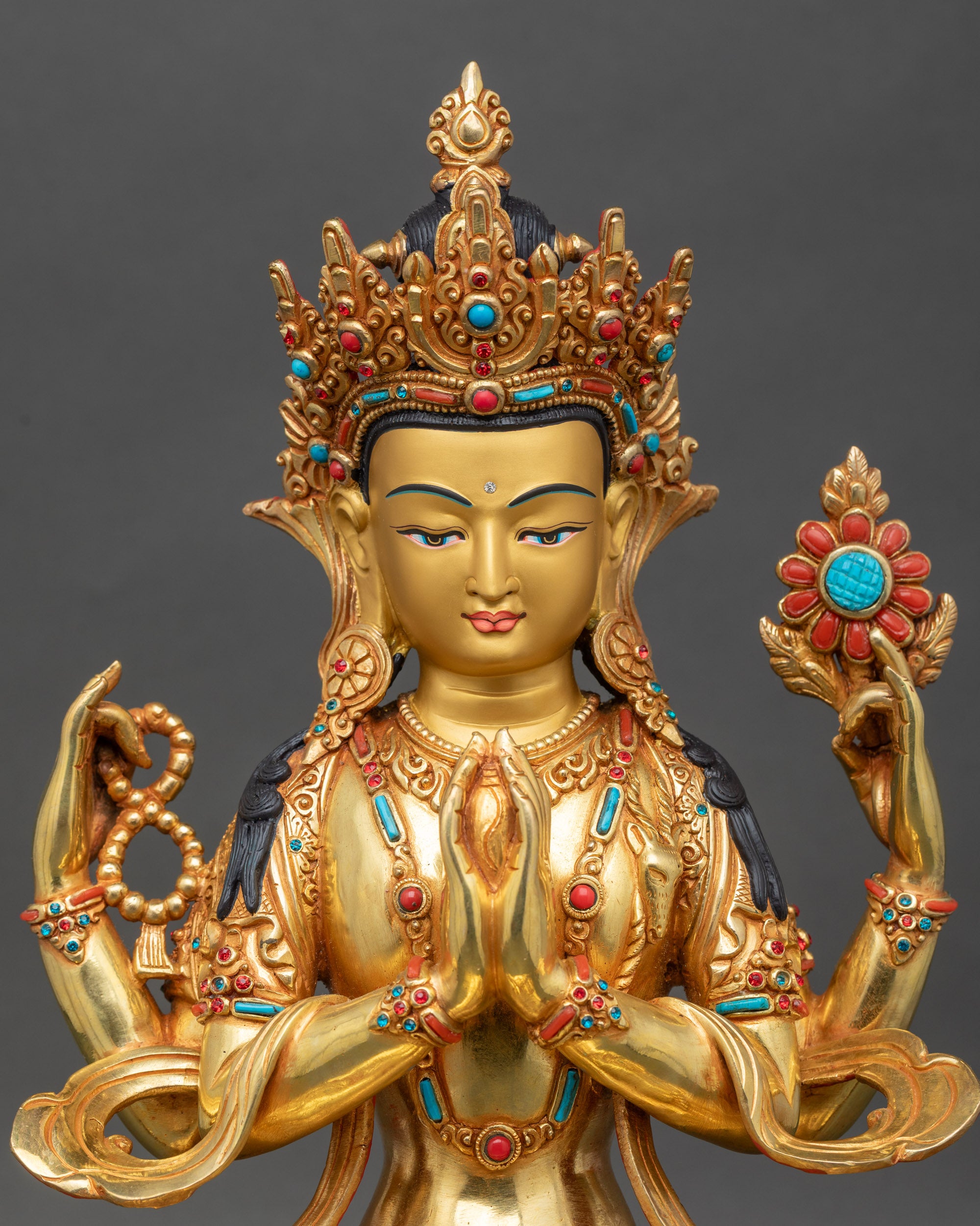 Close-up of Chenrezig sculpture showing fire gilding and stone inlay details