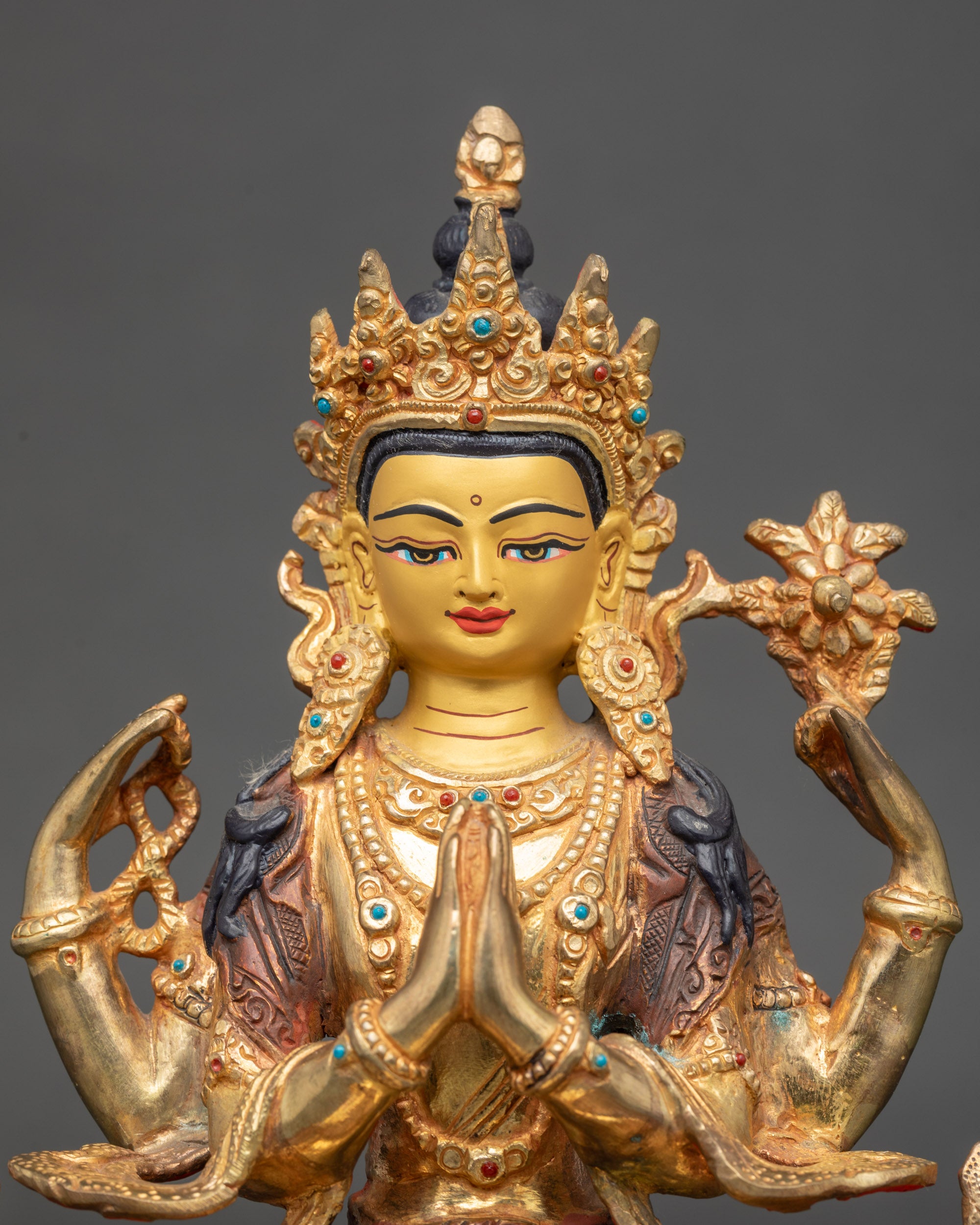 Close-up of Chenrezig statue face with 24K gold paint and premium acrylic colors