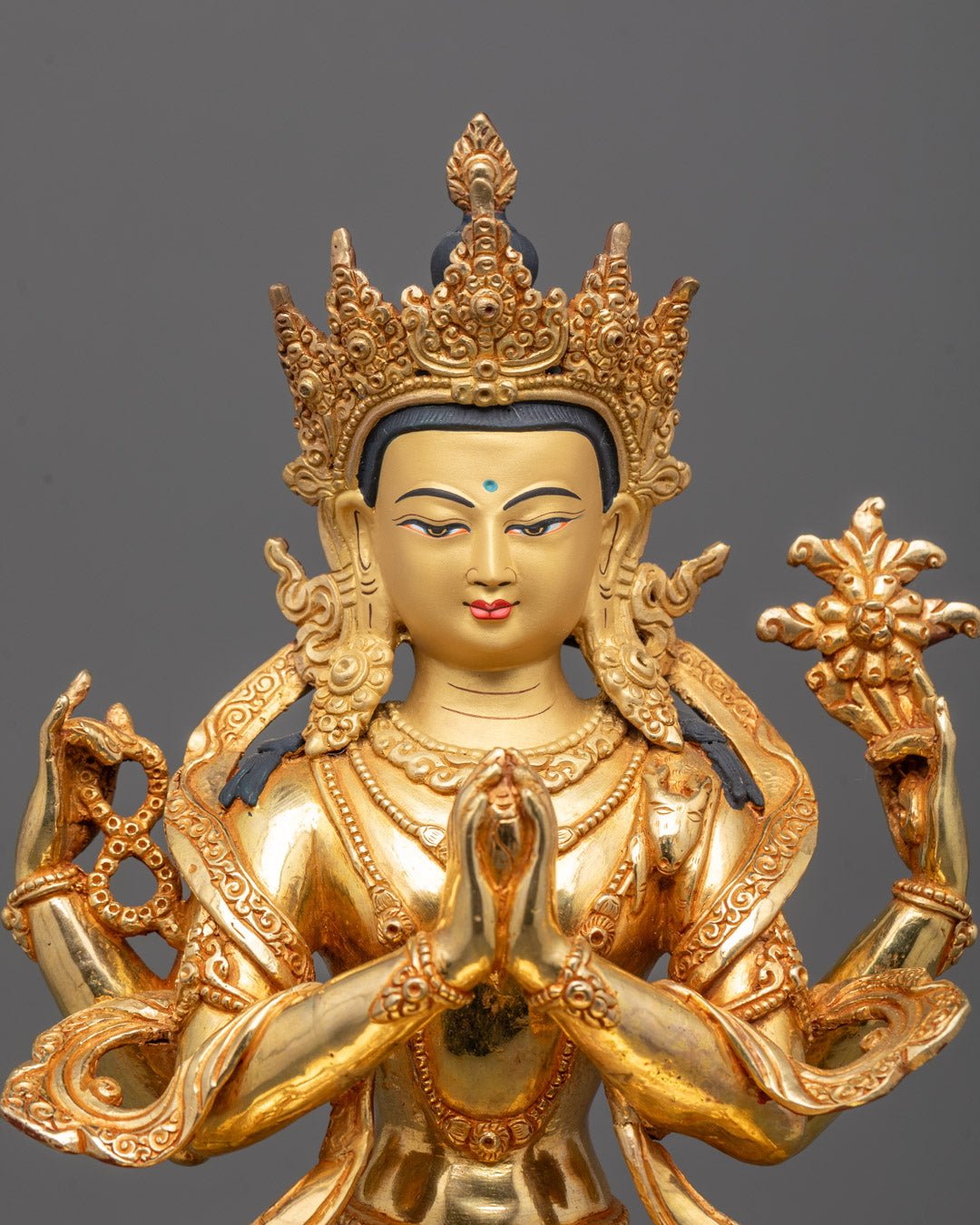 Close-up of Chenrezig statue showing multiple arms symbolizing compassion