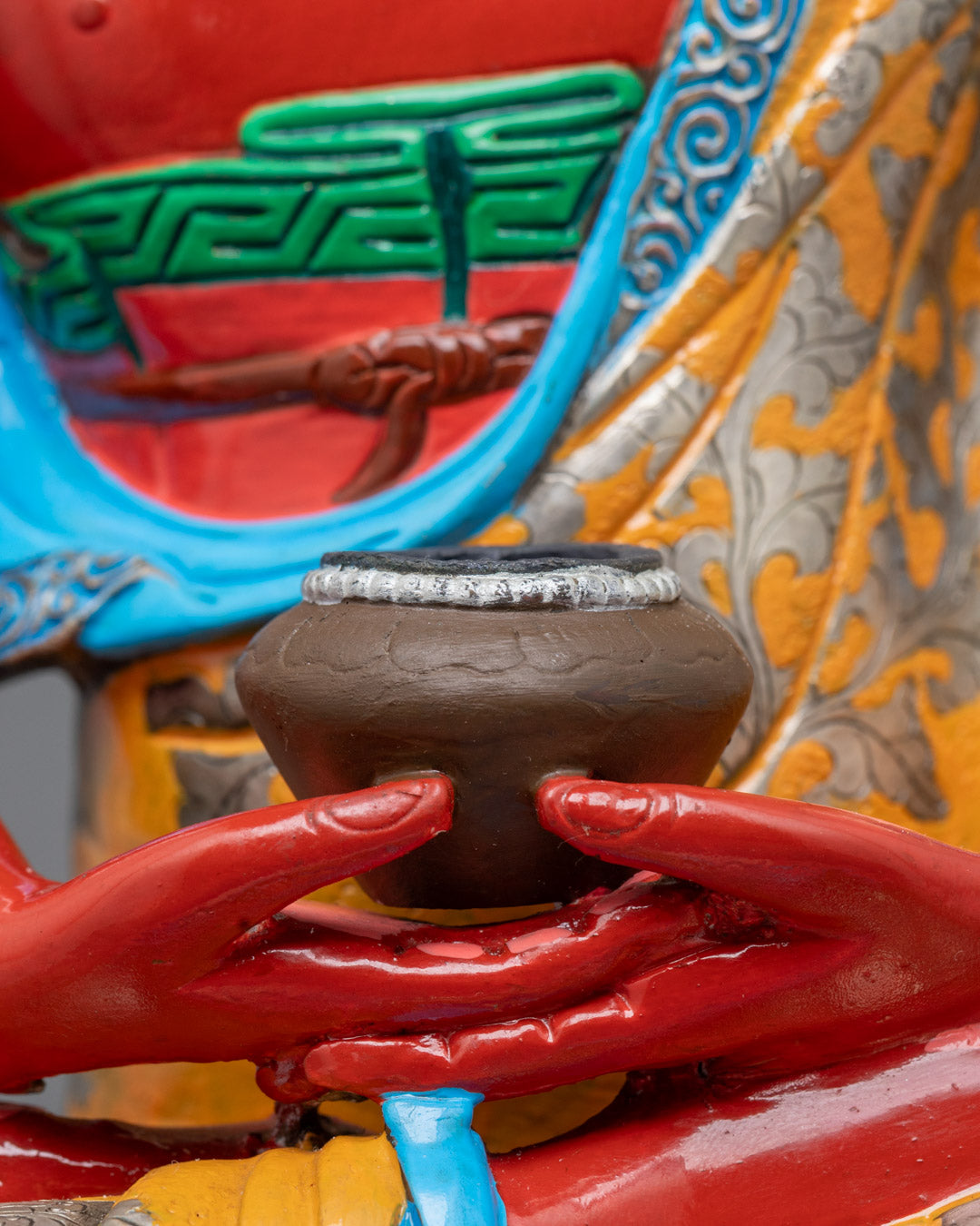 Close-up of Dhyana mudra and monk’s bowl on majestic Phowa Buddha statue