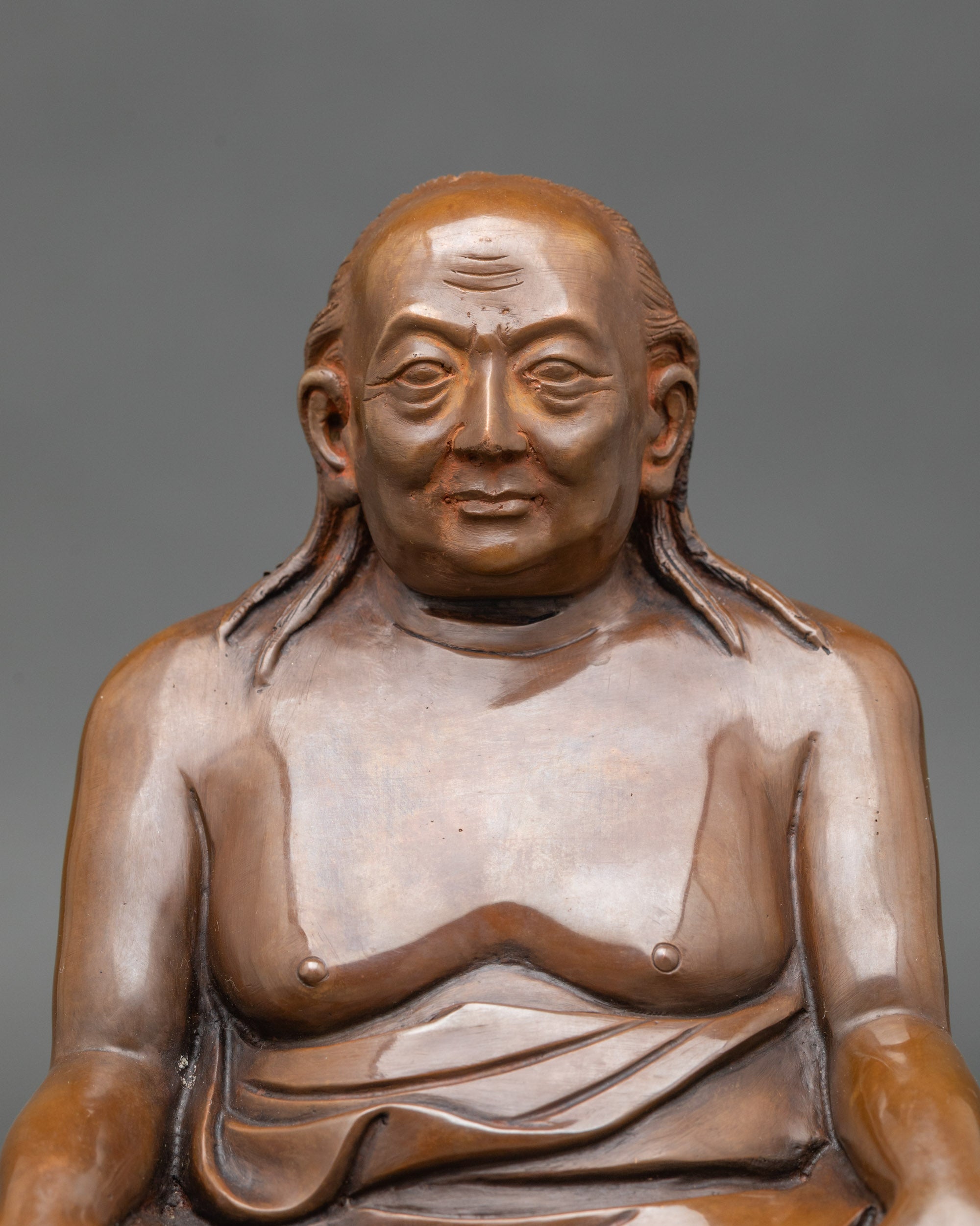 Close-up of Dilgo Khyentse Rinpoche figurine showing serene face and intricate robes