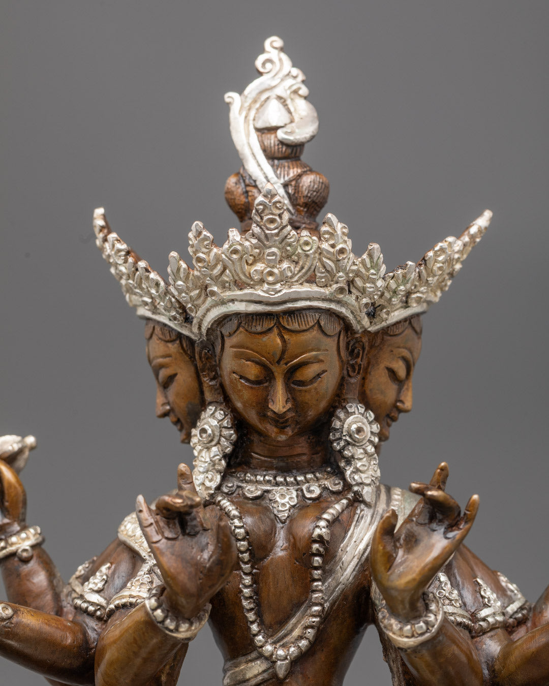 Close-up of Dukkar statue's face and jewelry showcasing lost wax carving and silver finish