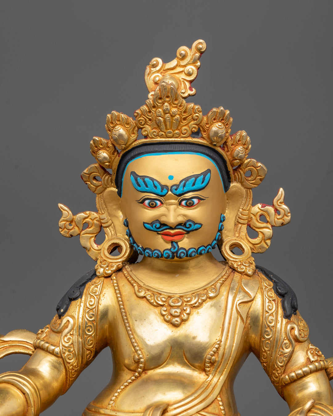 Close-up of Dzambhala sculpture’s intricate crown and giant carved halo details.