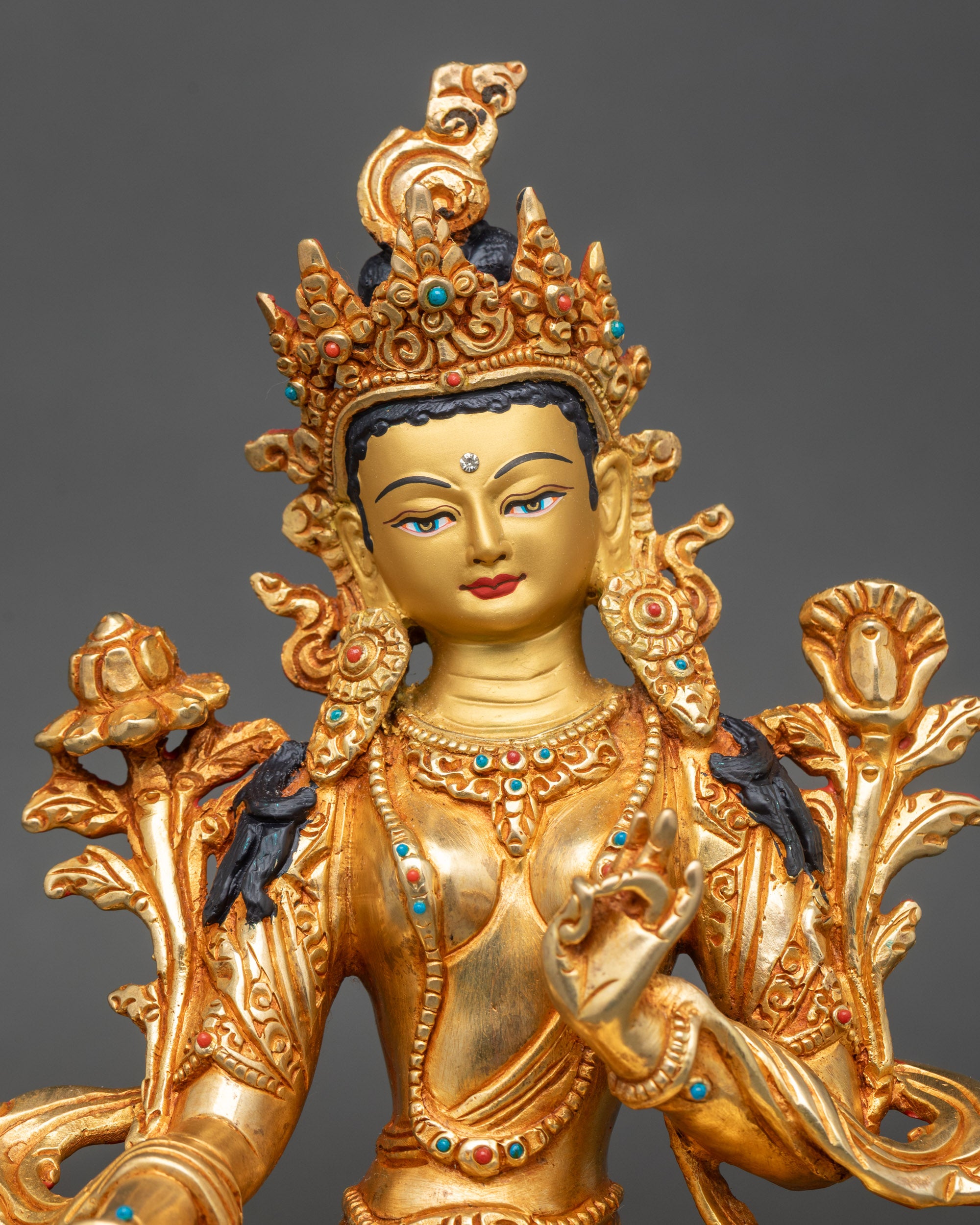 Close-up of Green Tara Bodhisattva face, gold fire-gilded and hand-painted details