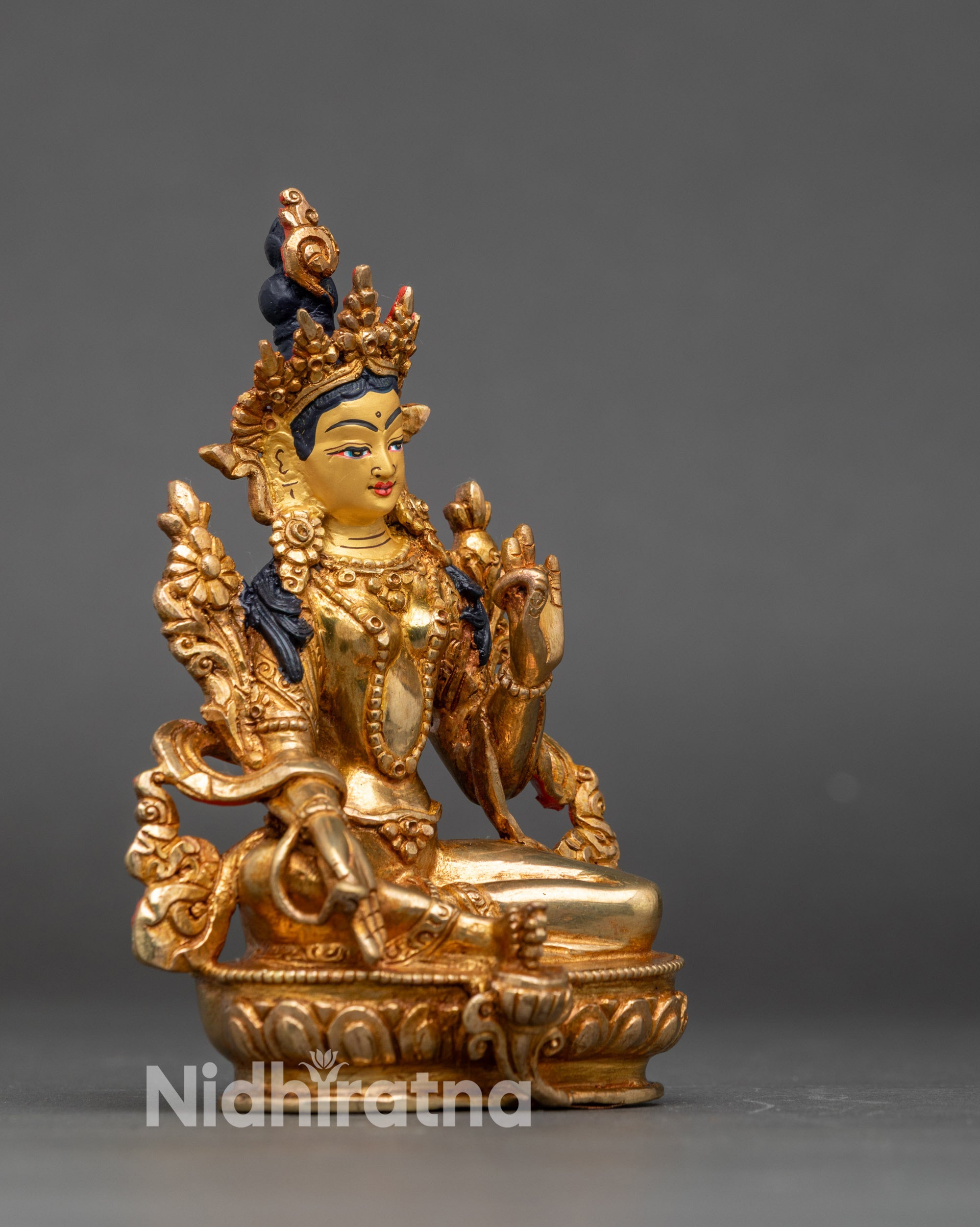Close-up of Green Tara Bodhisattva sculpture showing intricate Newari artisan details