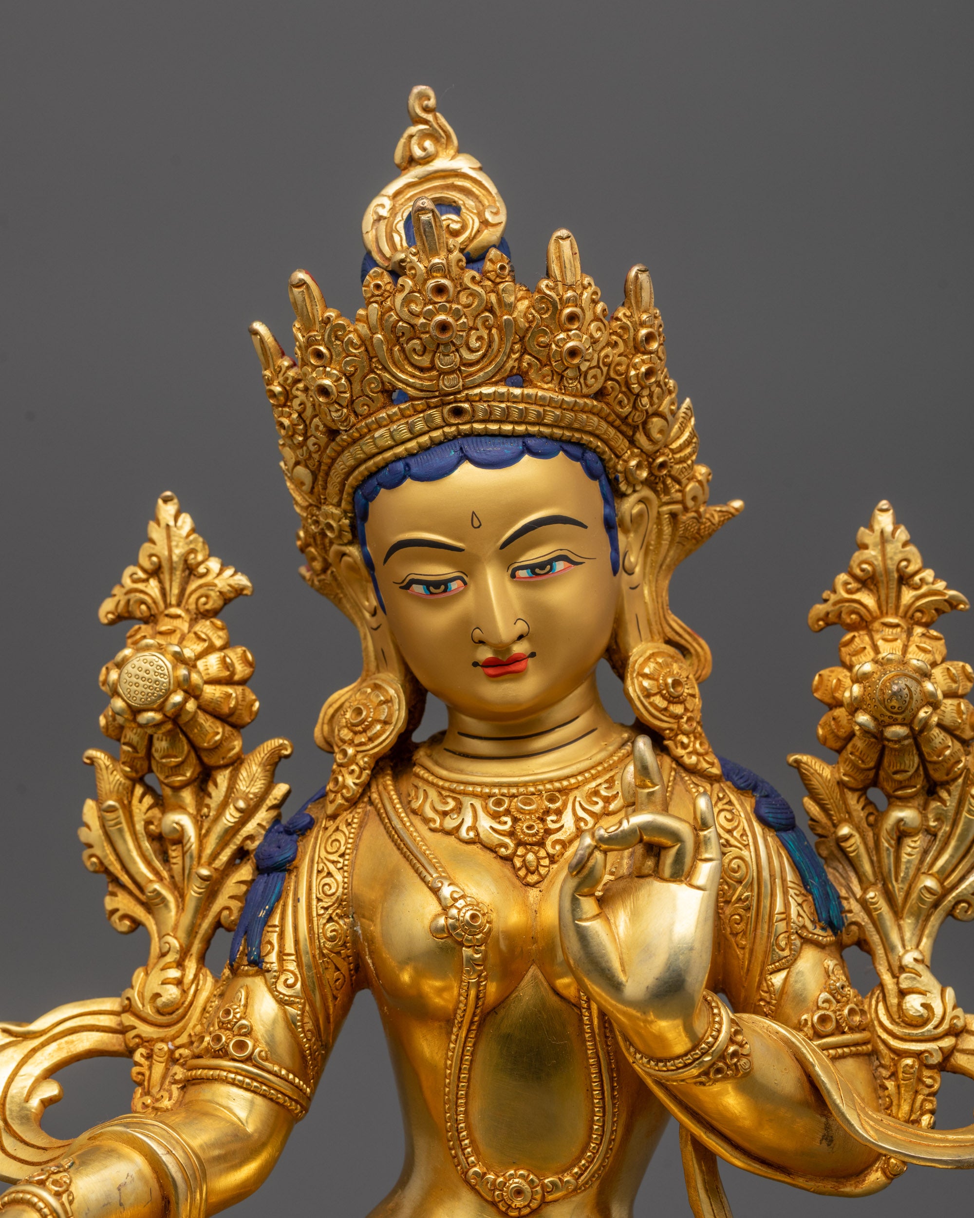 Close-up of Green Tara Statue face polished with pure 24k gold showing serene