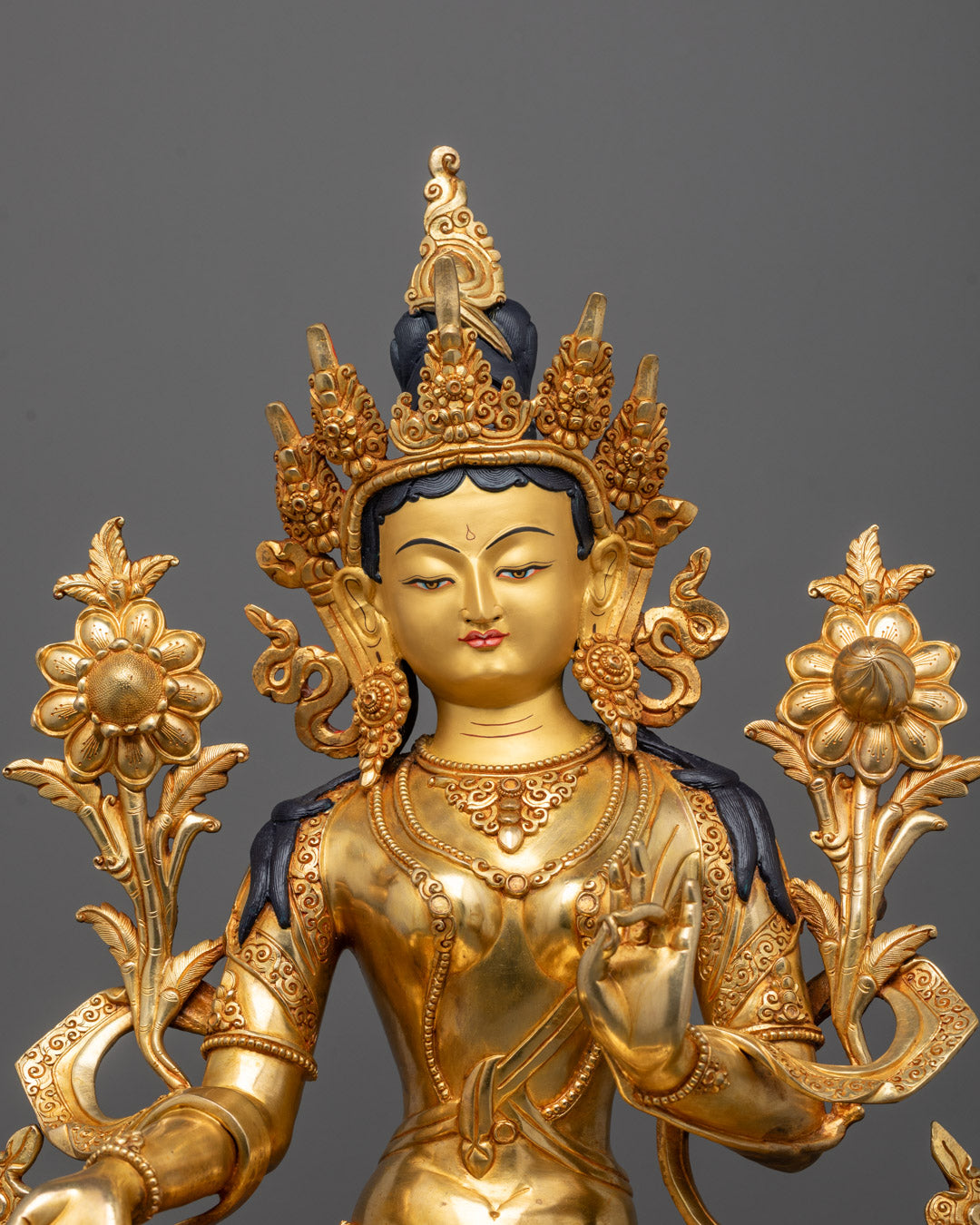 Close-up of Green Tara’s serene face and crown