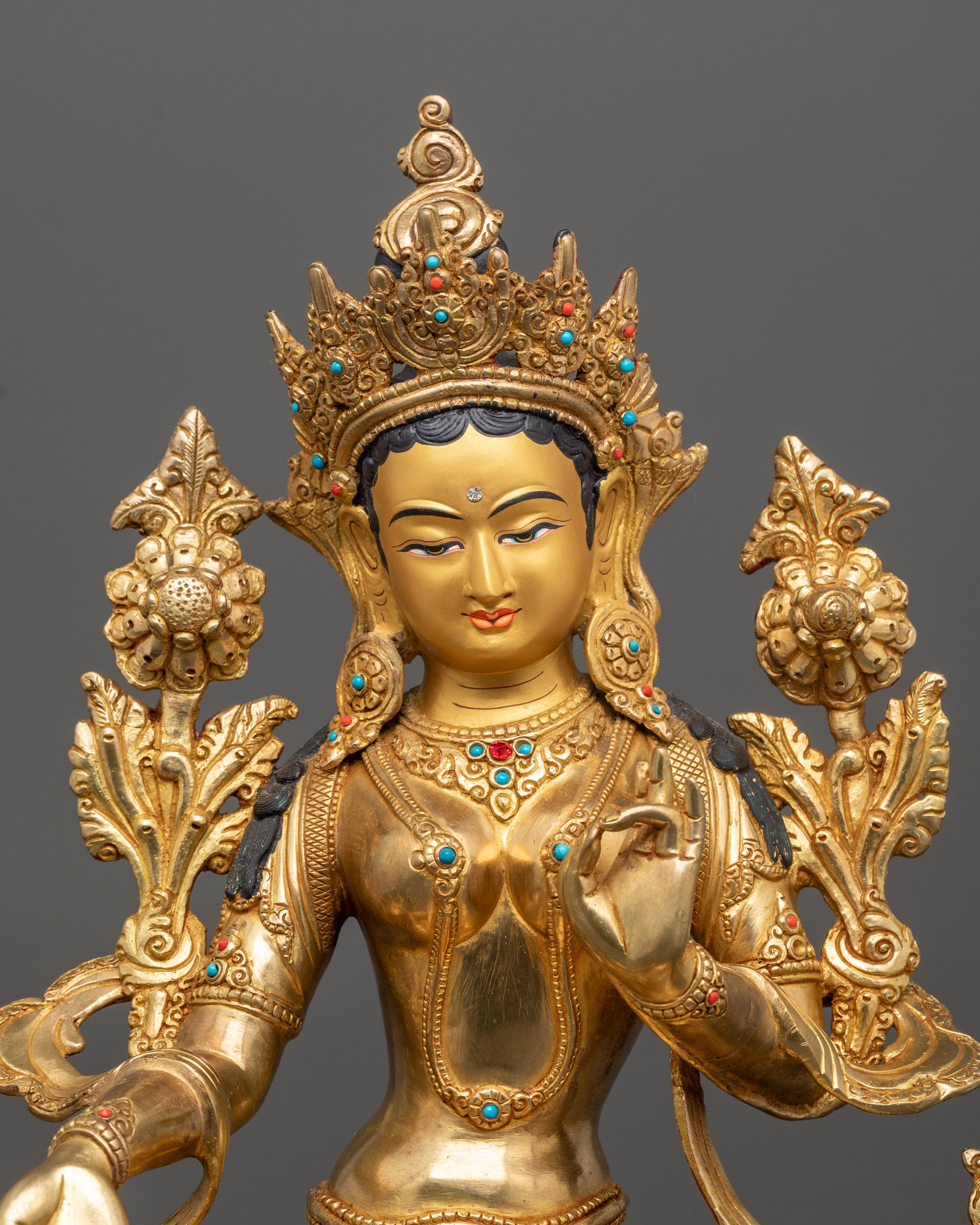 Close-up of Green Tara’s serene face and intricate crown detailing, showcasing the skilled
