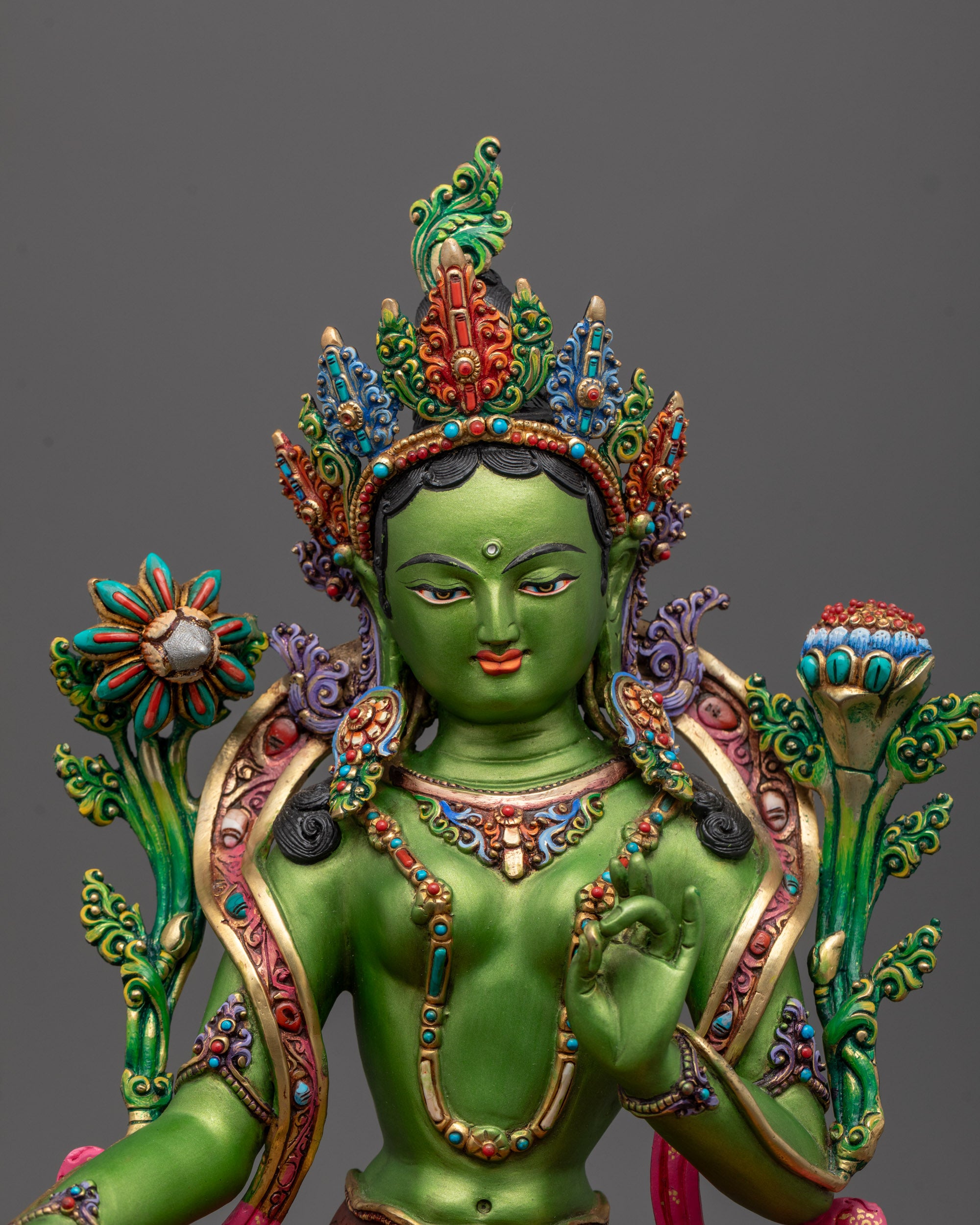 Close-up of Green Tara’s serene face with fine facial detailing, symbolizing compassion