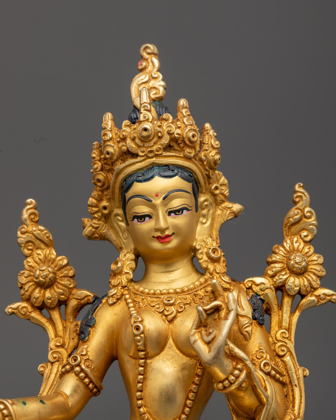 Green Tara’s serene face with pure 24k fire-gold gilded finish and intricate detailing.