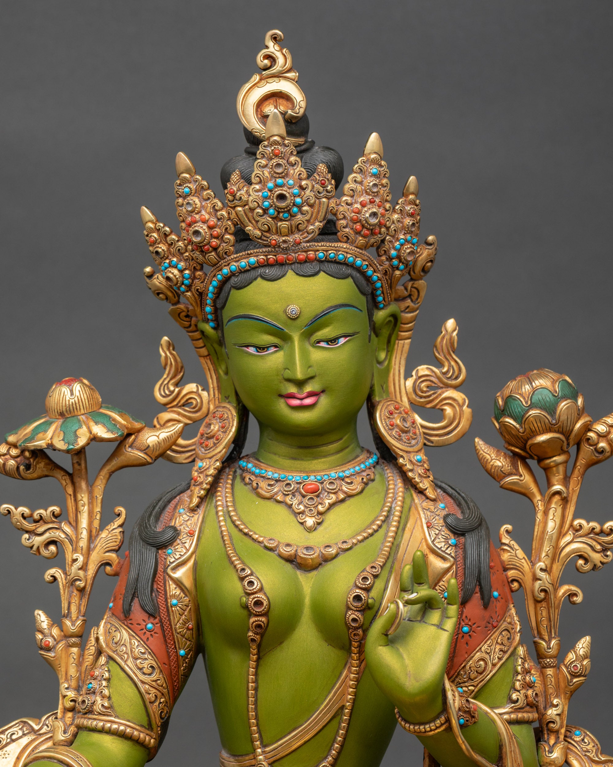 Close-up of Green Tara statue showing detailed face and serene expression