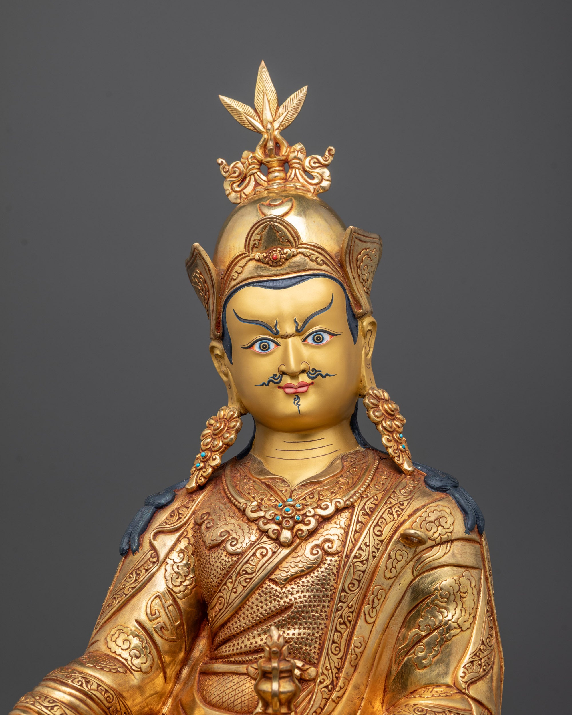 Close-up of Guru Rinpoche Statue with 24k Gold Gilded Face and Vajra in Hand