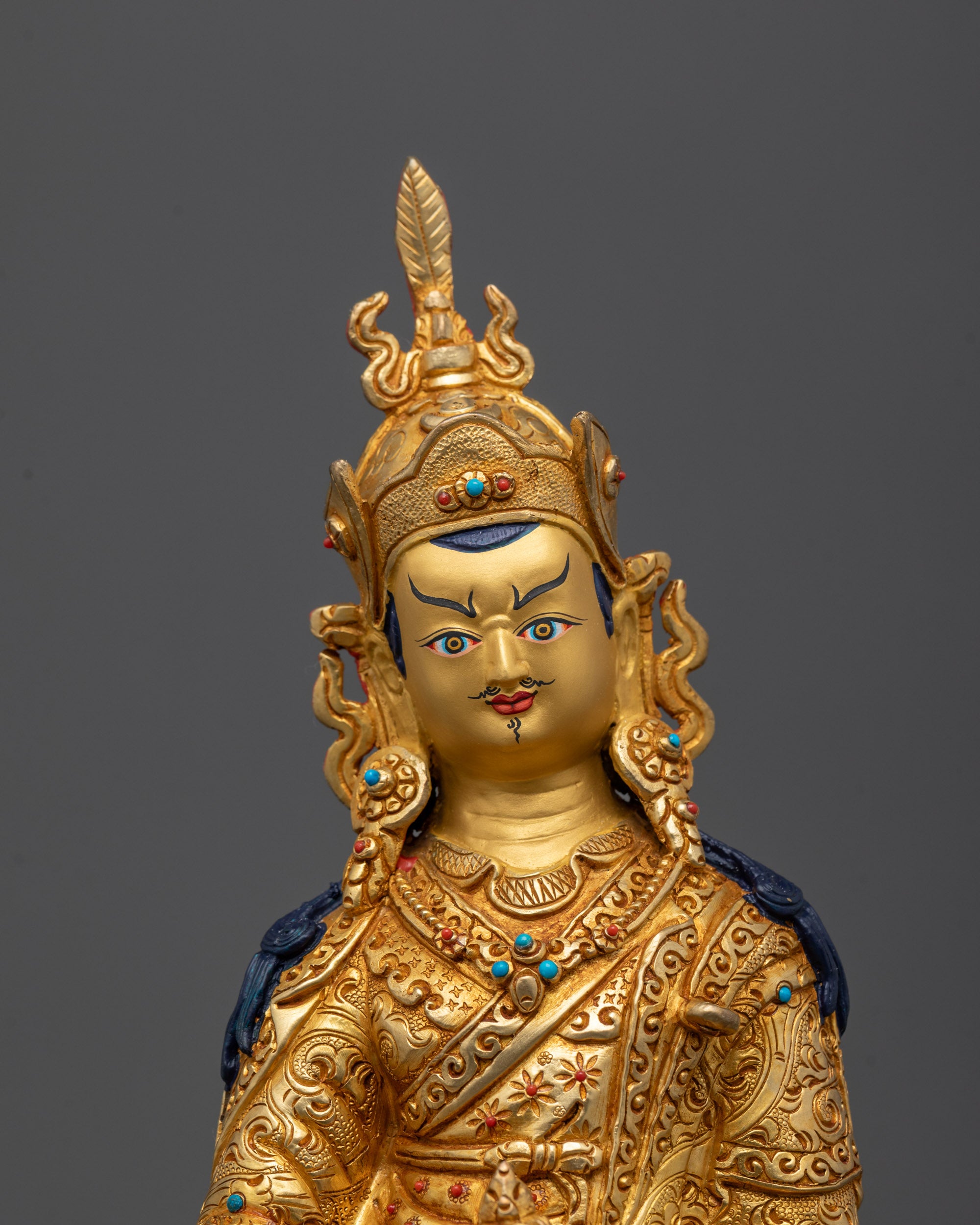 Close-up of Guru Rinpoche’s serene face and hand gestures showcasing