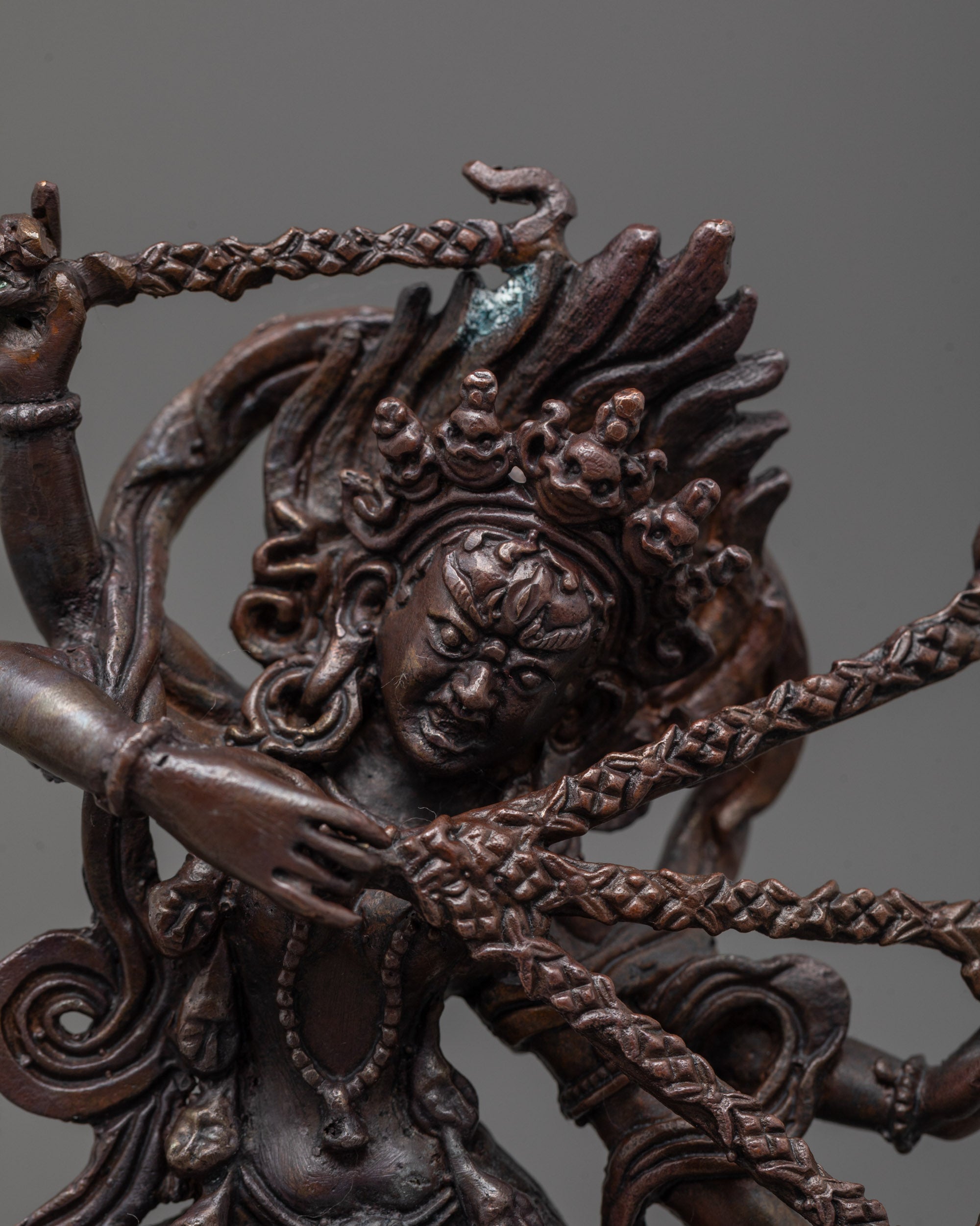 Close-up of Kurukulla Statue face with skull crown and oxidized copper detailing