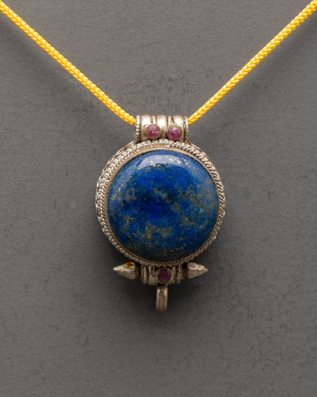 Close-up of Lapis Lazuli stone and coral detailing on Tibetan silver locket pendant