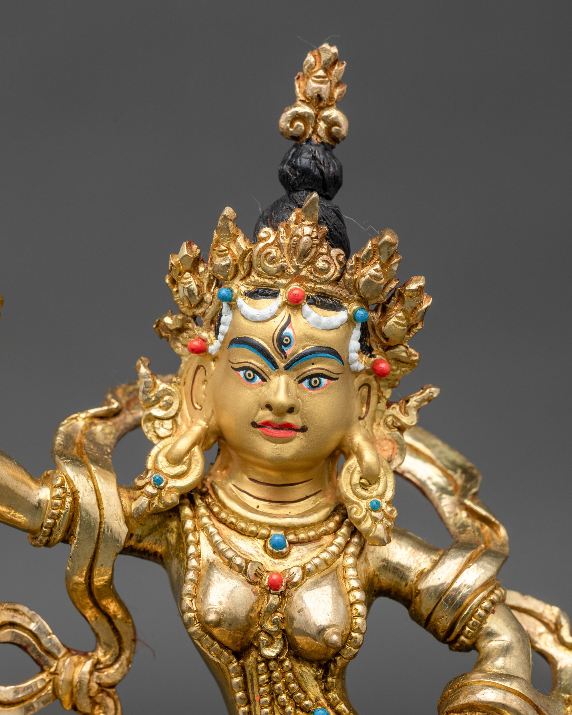 Close-up of Machig Labdron face with gold gilded finish and serene expression