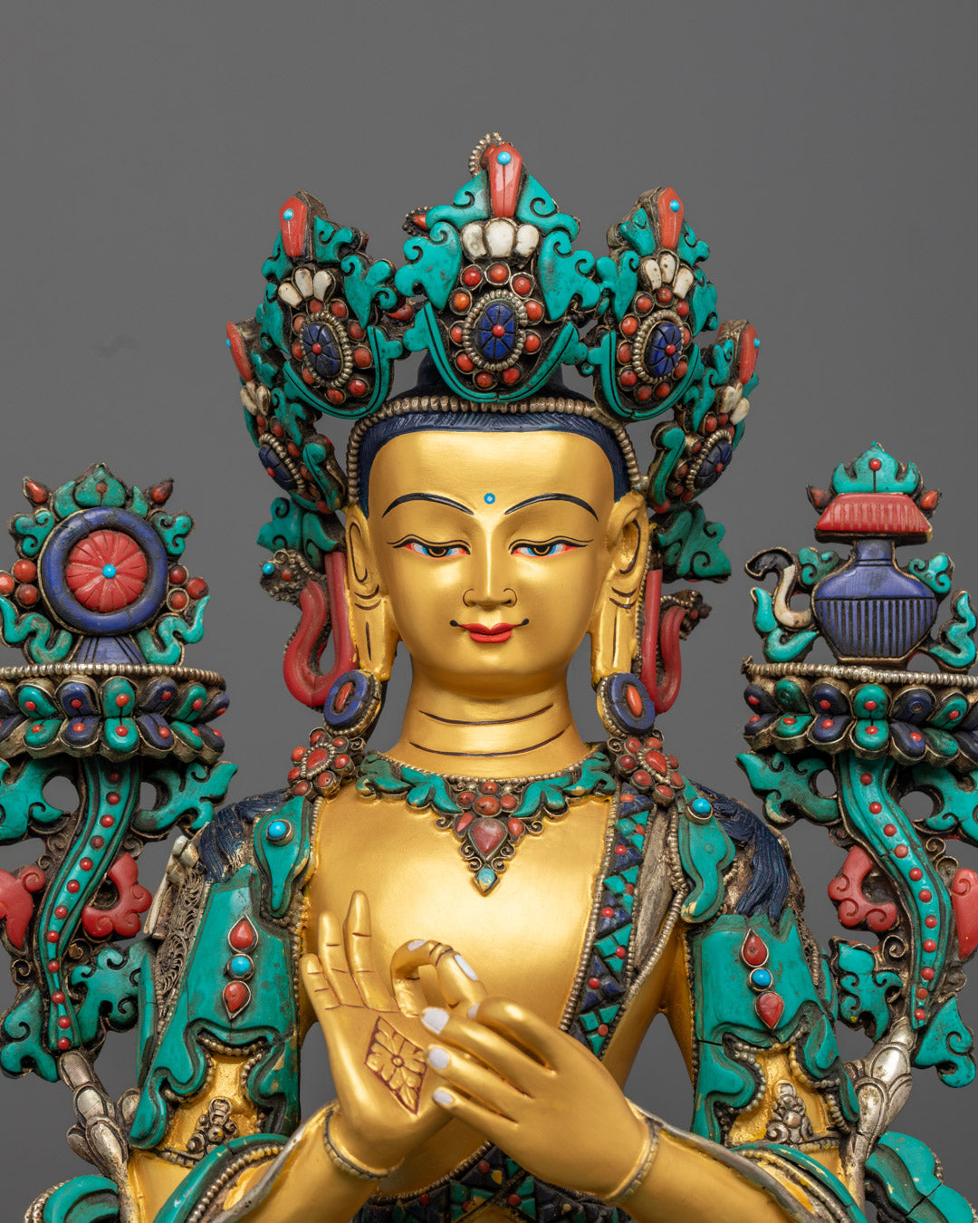 Maitreya Buddha's throne adorned with vibrant turquoise, coral, and lapis lazuli gemstone inlays