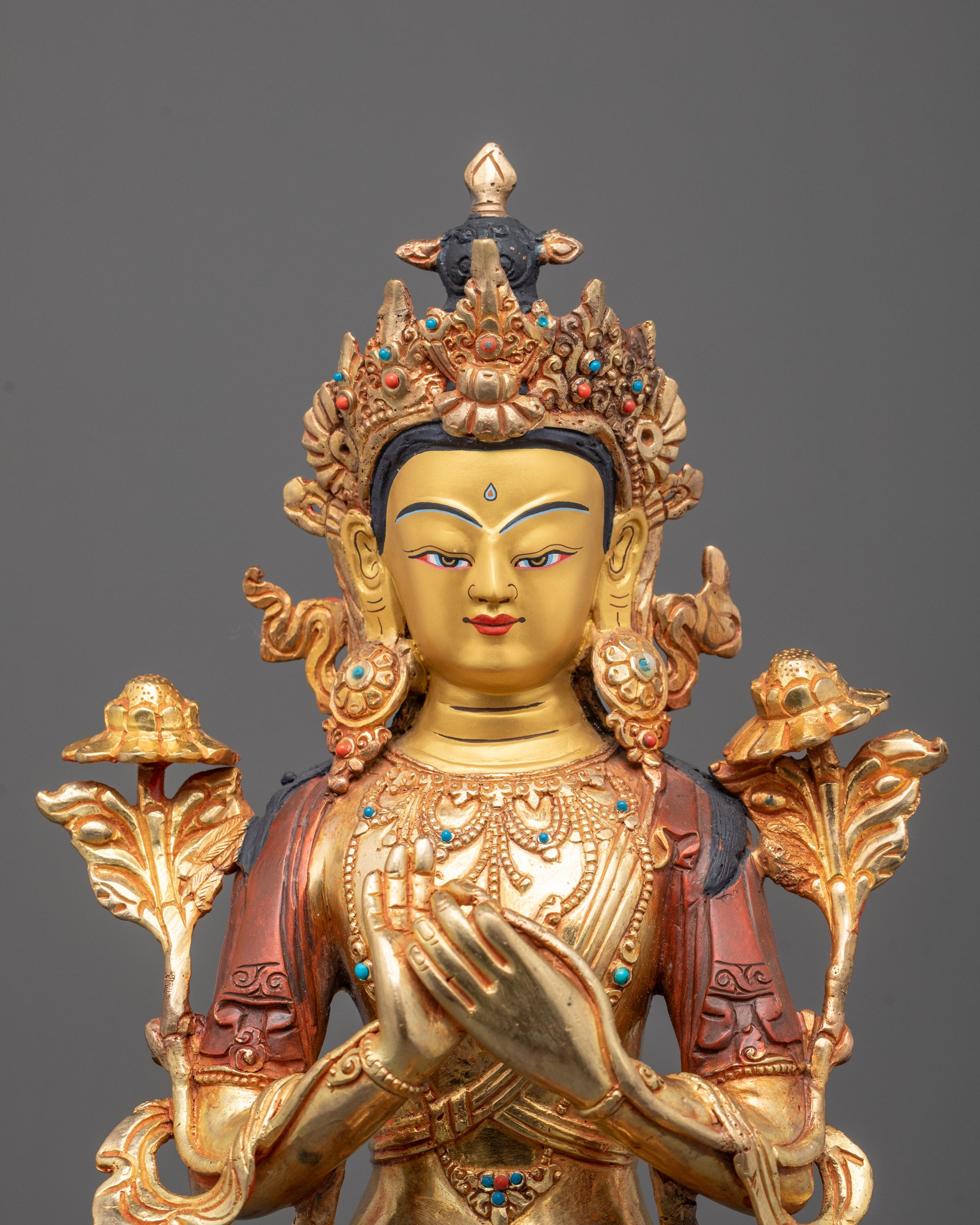Close-up of Maitreya Buddha’s gold-gilded face, five-jewel crown, and semi-precious stones