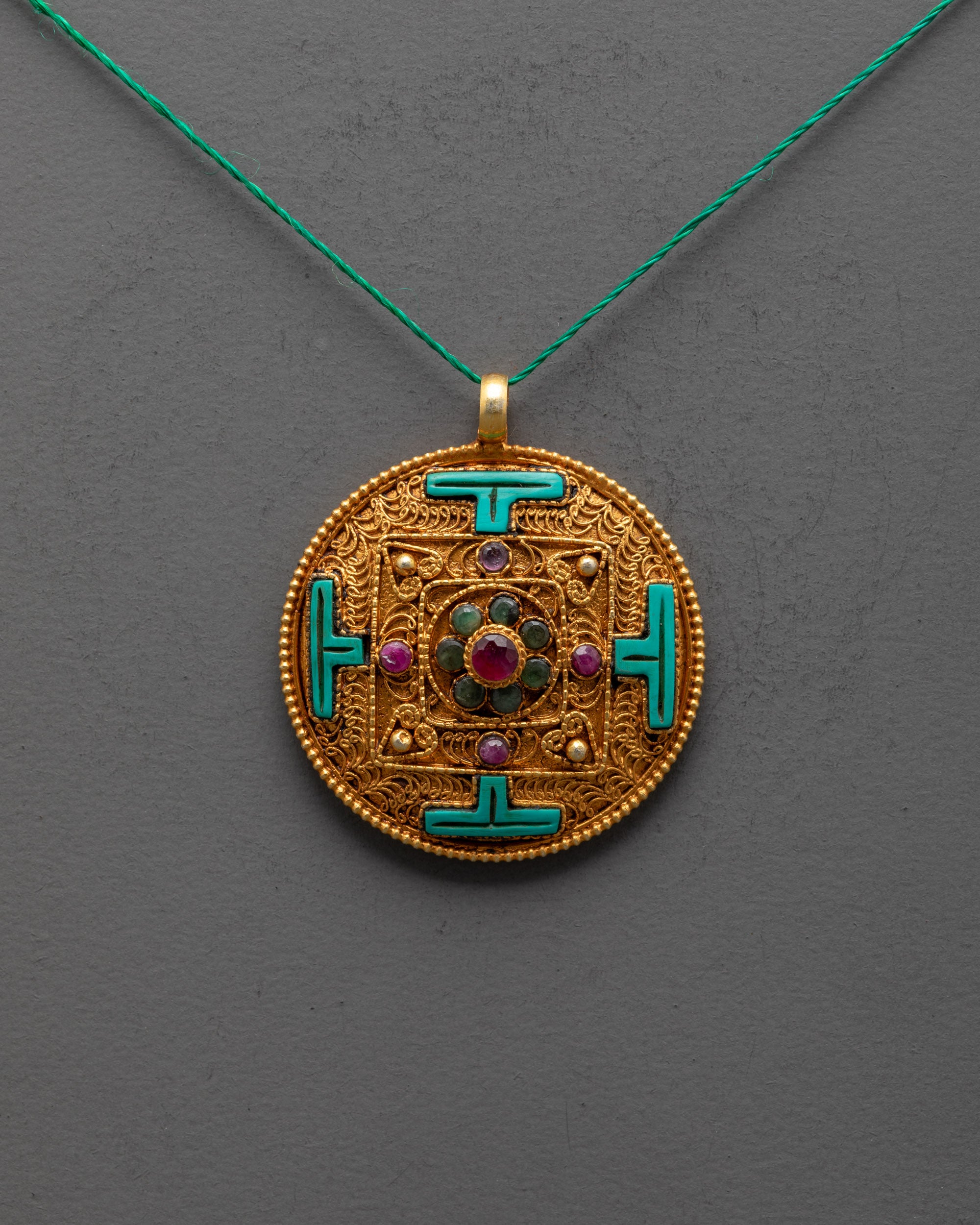 Close-up of Mandala Locket filigree design and gemstone details