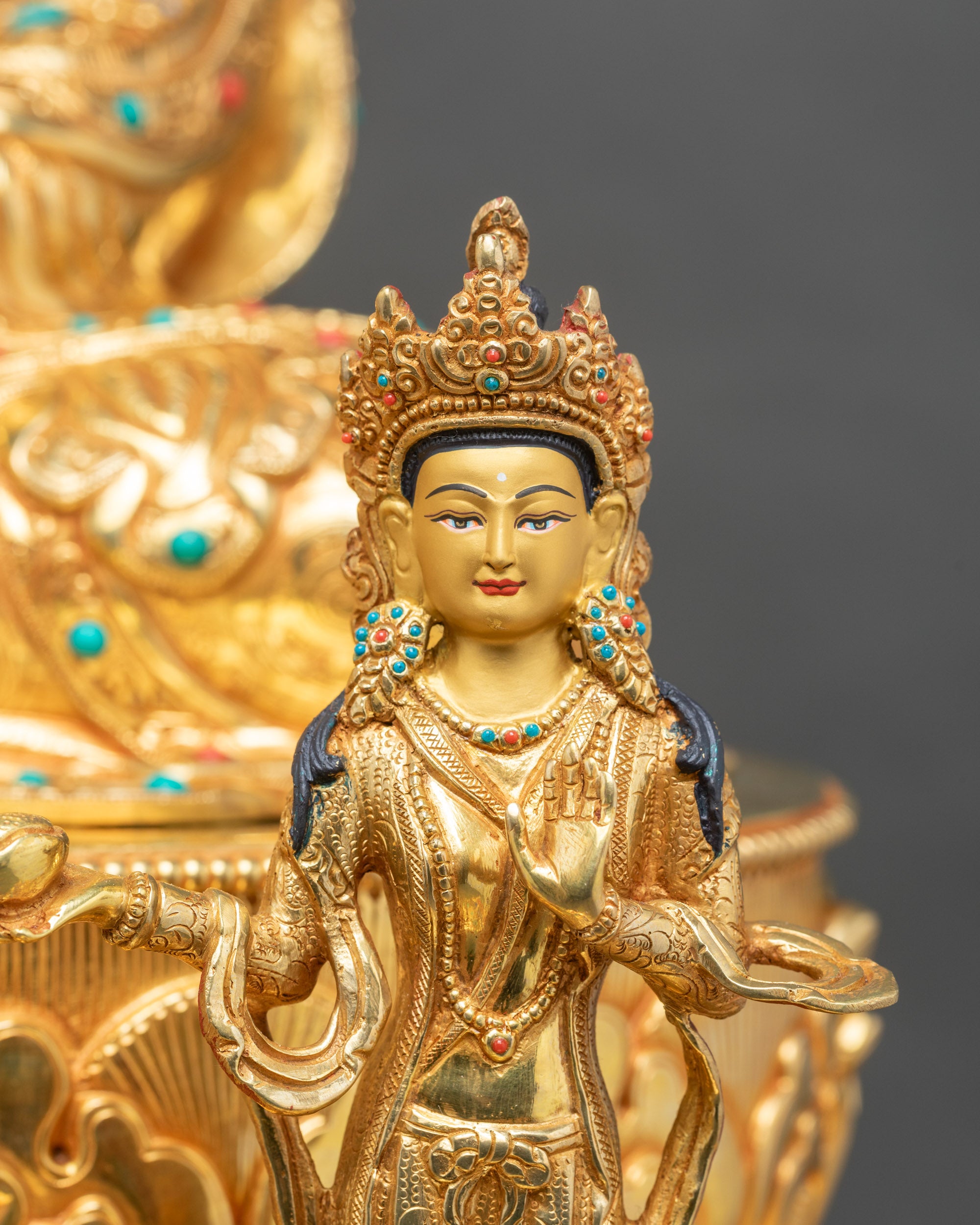 Close-up of Mandarva statue showing intricate attire and serene expression