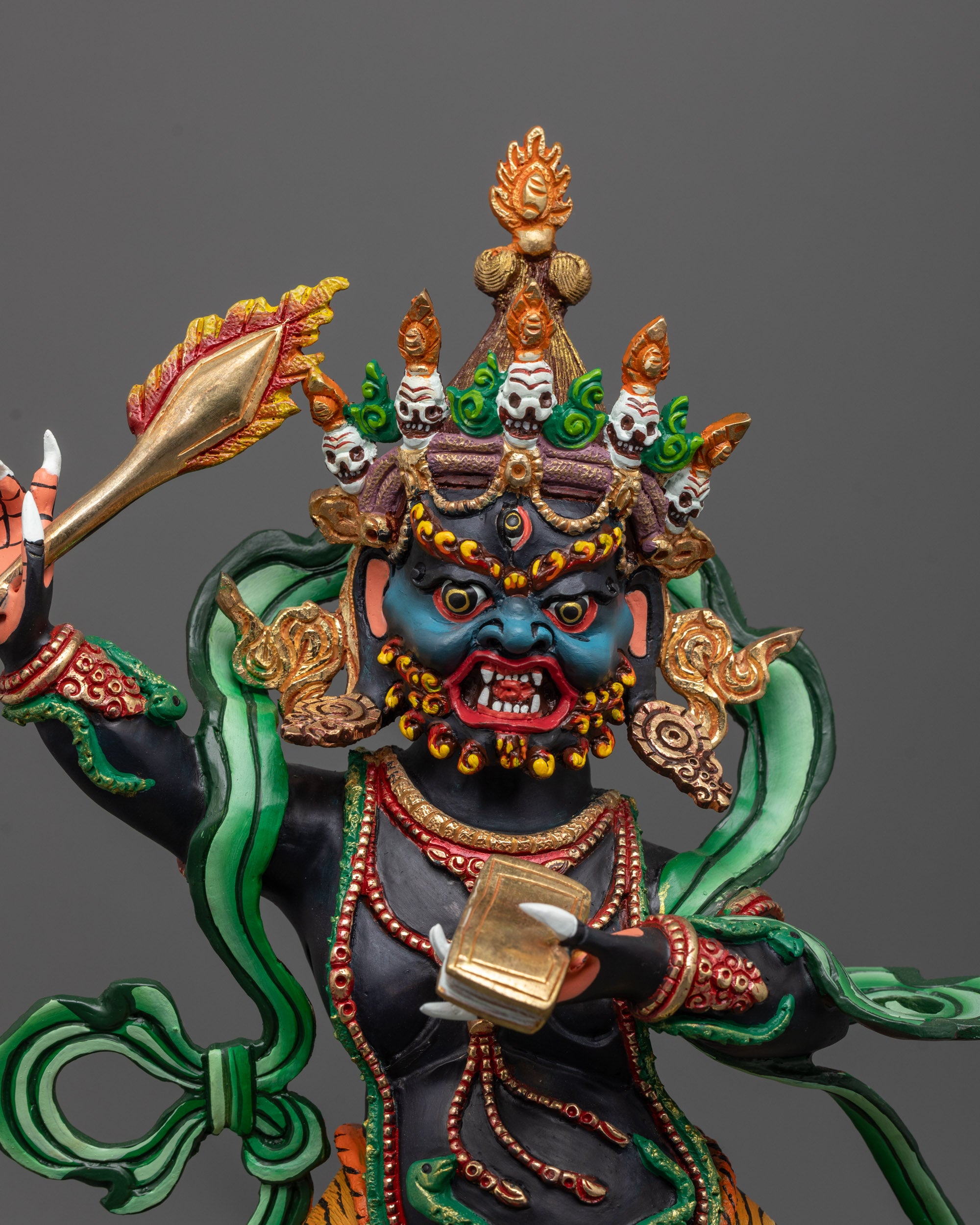 Close-up of Manjushri holding flaming sword and Prajnaparamita text