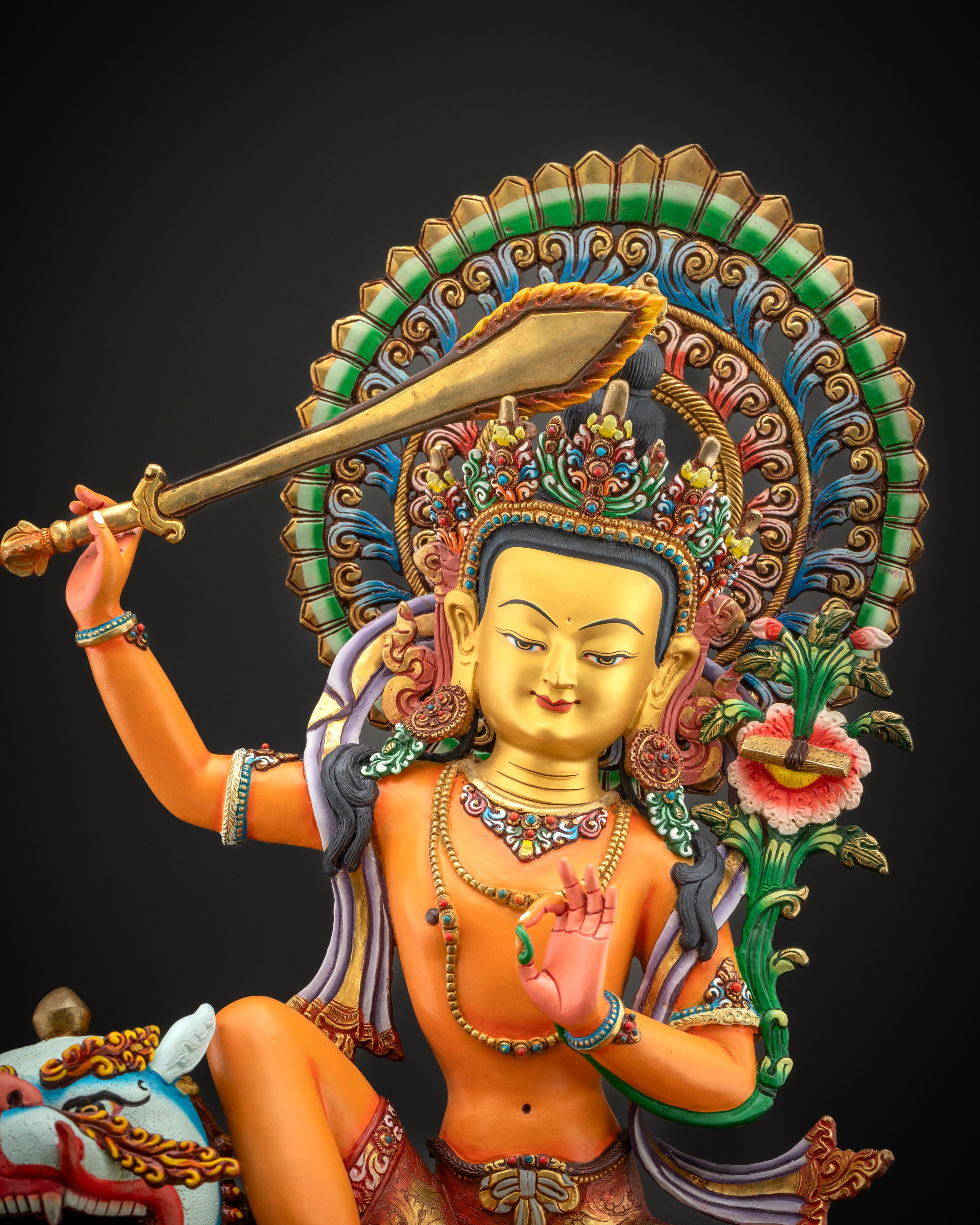 Close-up of Manjushri’s 24k gold gilded face and ornate hand-painted features symbolizing wisdom