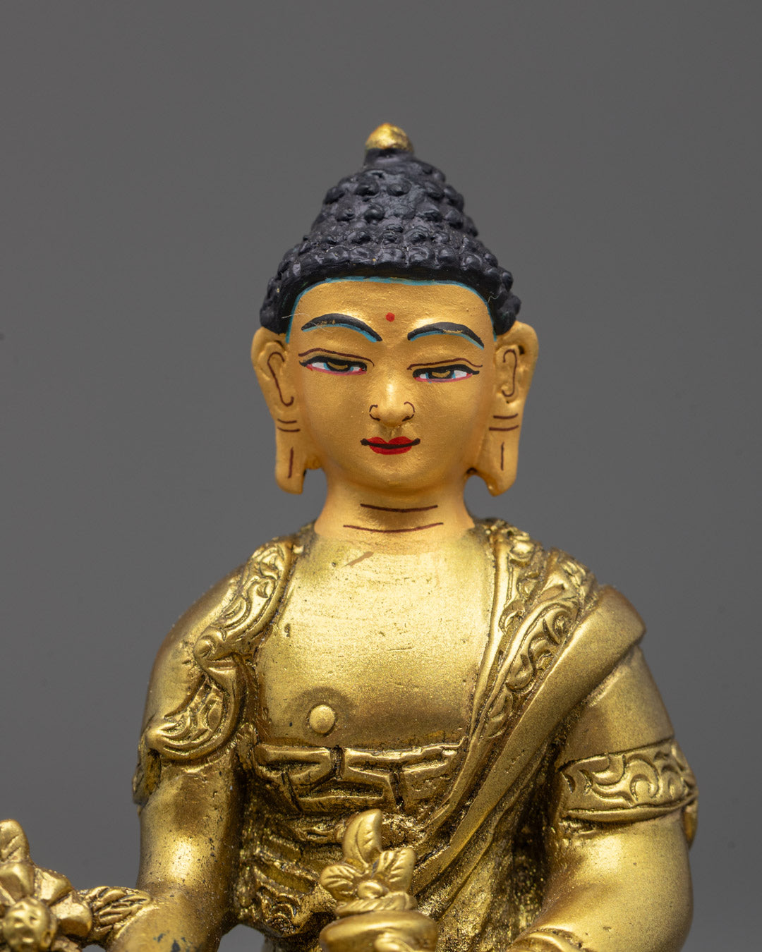 Close-up of Medicine Buddha with myrobalan and healing bowl in gold fire-gilded finish