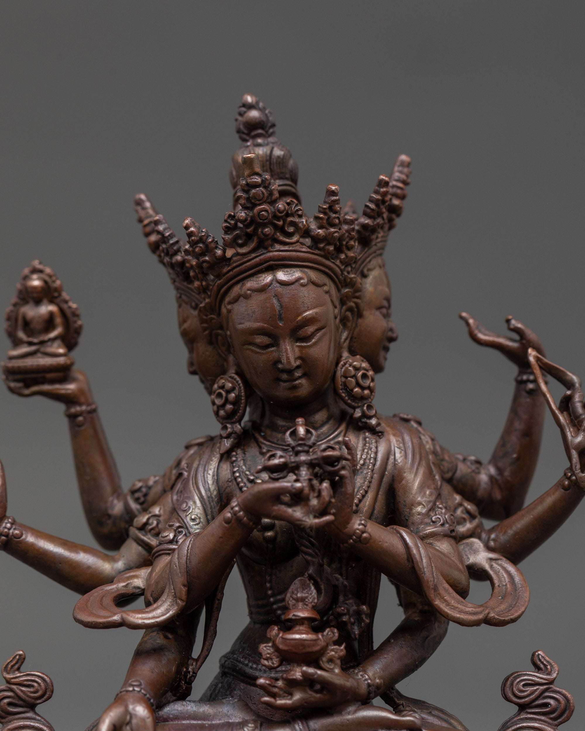 Close-up of Namgyalma Oxidized Statue revealing detailed copper texture and sacred symbols like Vishva Dorje and vase