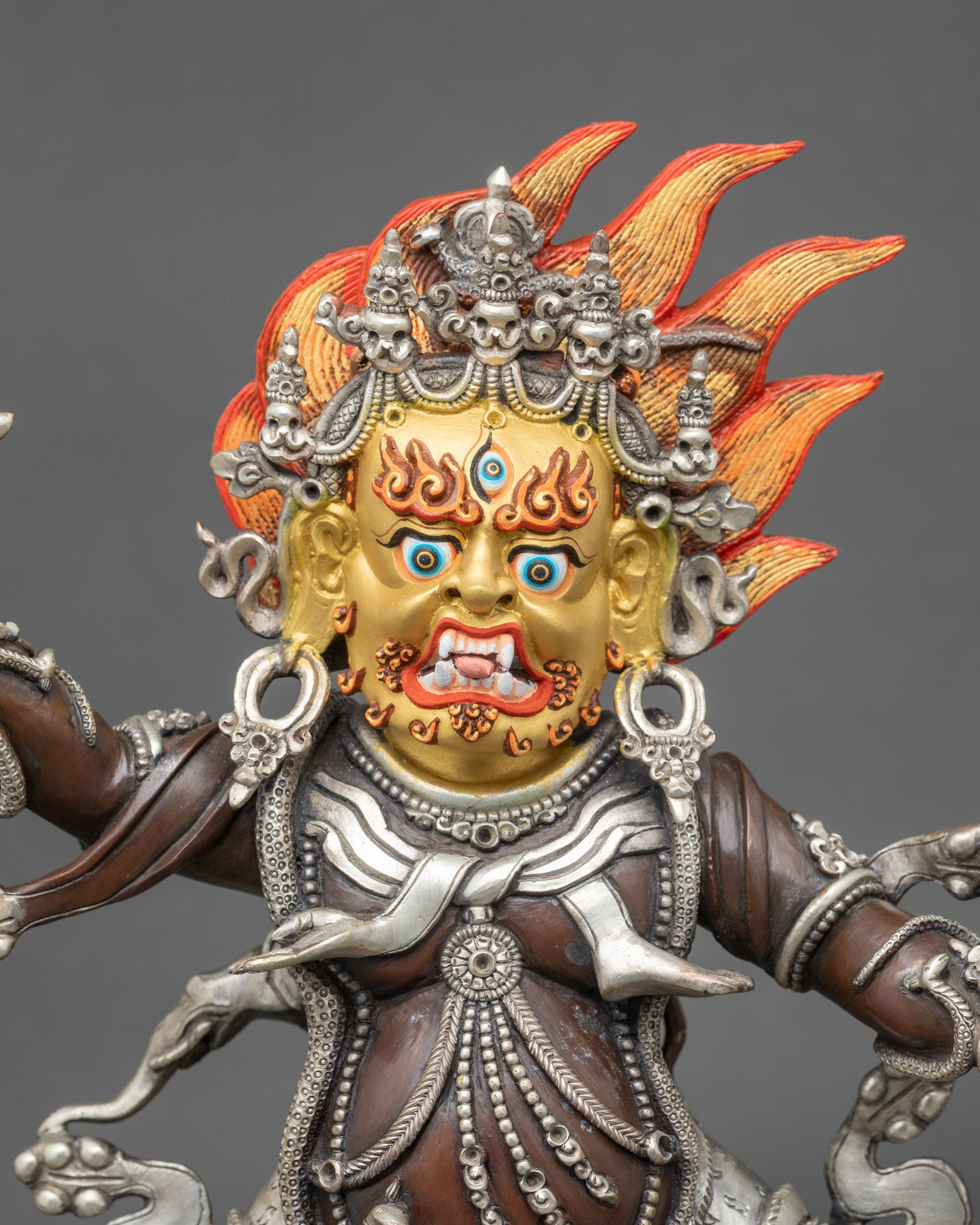 Close-up of Nepalese Guru Drakpo Buddhist protector deity holding vajra and black scorpion