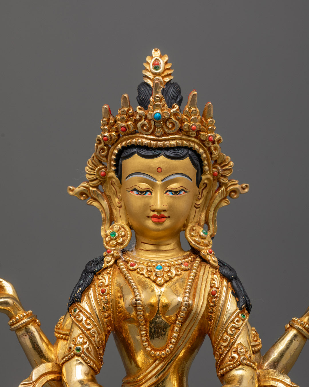 Close-up of Praja Paramita statue’s gold fire-gilded body and semi-precious stones detail